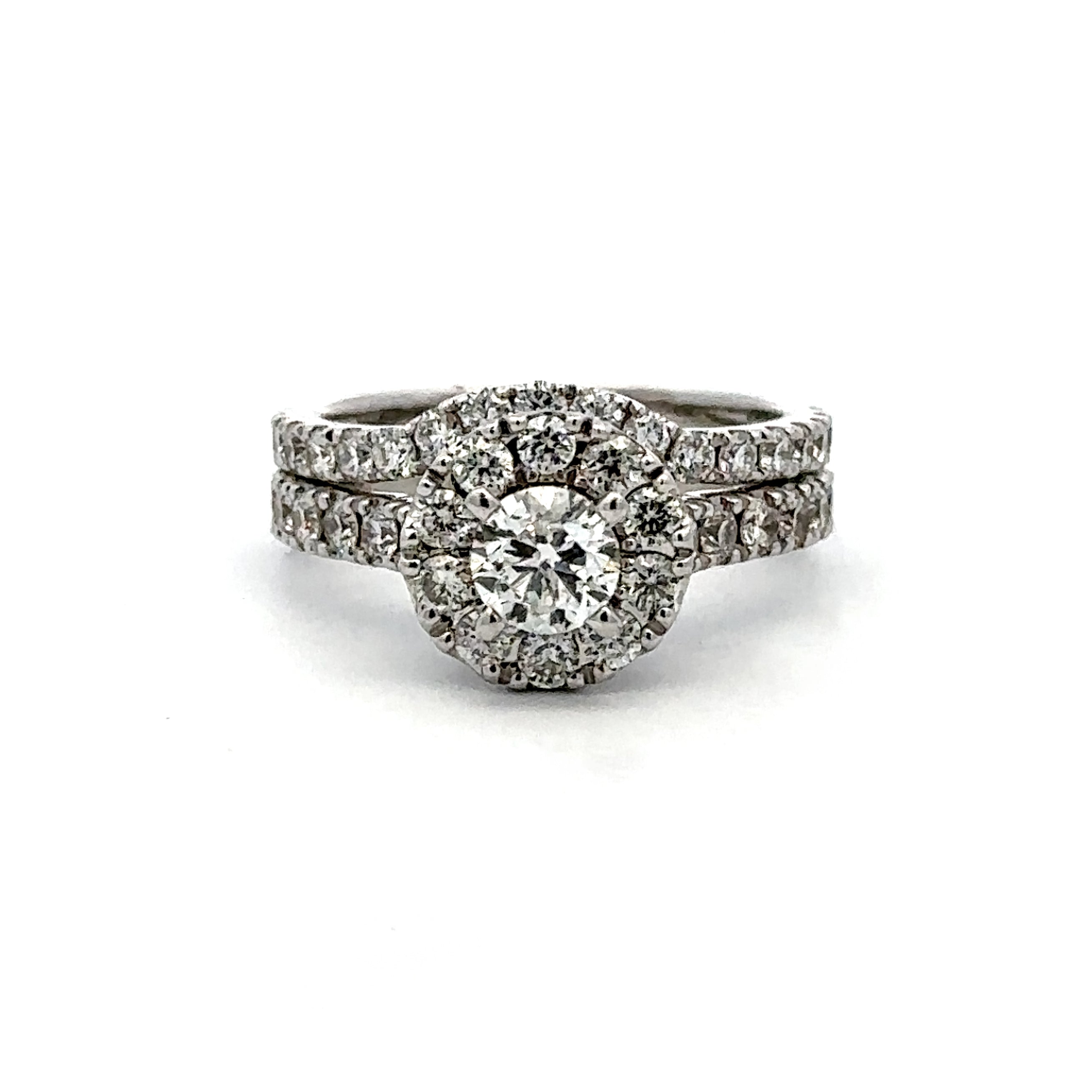 A silver-toned diamond ring set featuring a round-cut center stone surrounded by a double halo of small diamonds, with matching pavé bands, shown on a plain white background.