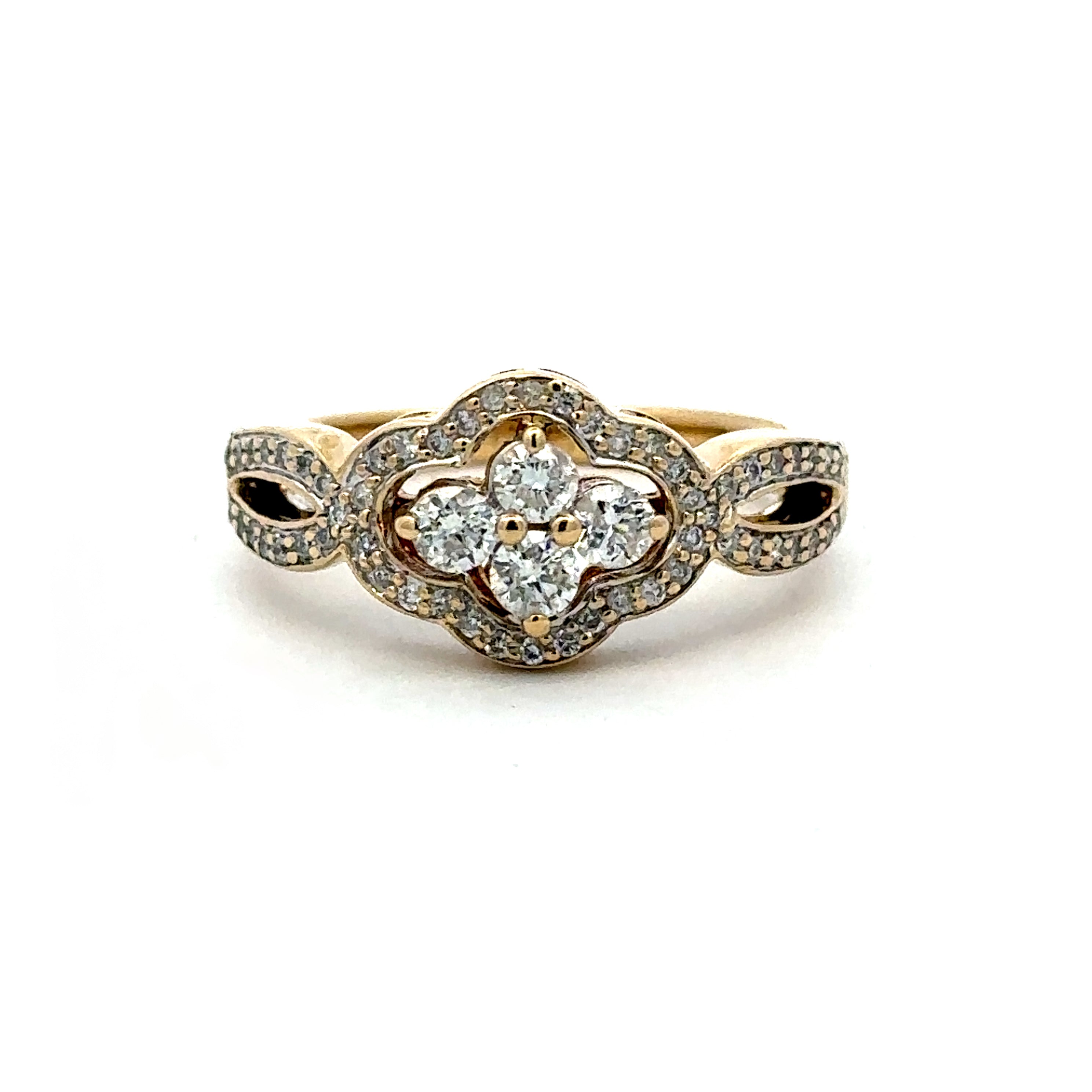 A yellow gold ring featuring a four-petal clover motif set with small pavé diamonds and a central cluster of four round-cut diamonds, shown on a plain white background.