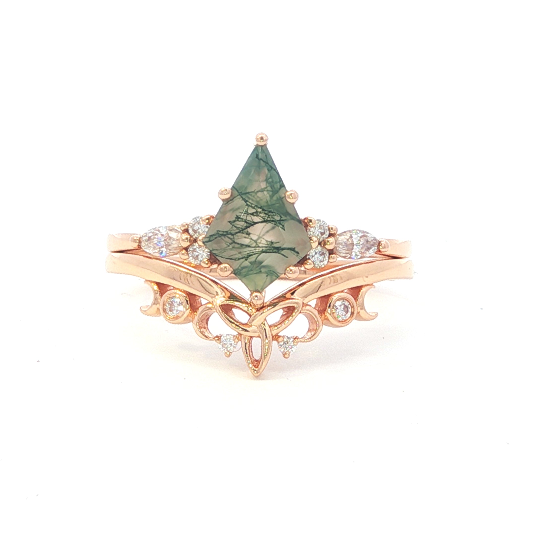 Rose gold ring with a green stone and diamond accents on a white background