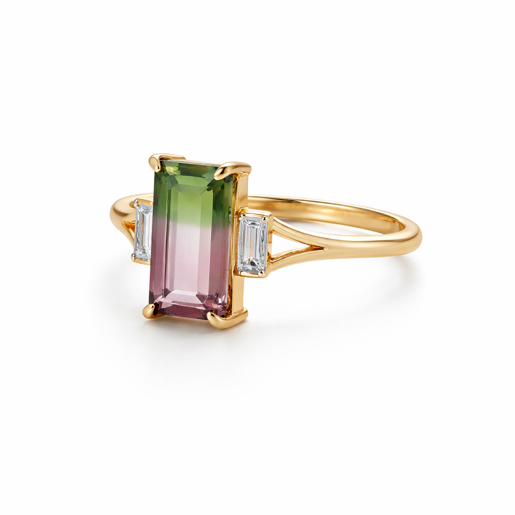 Gold ring with a green and pink gemstone on a white background