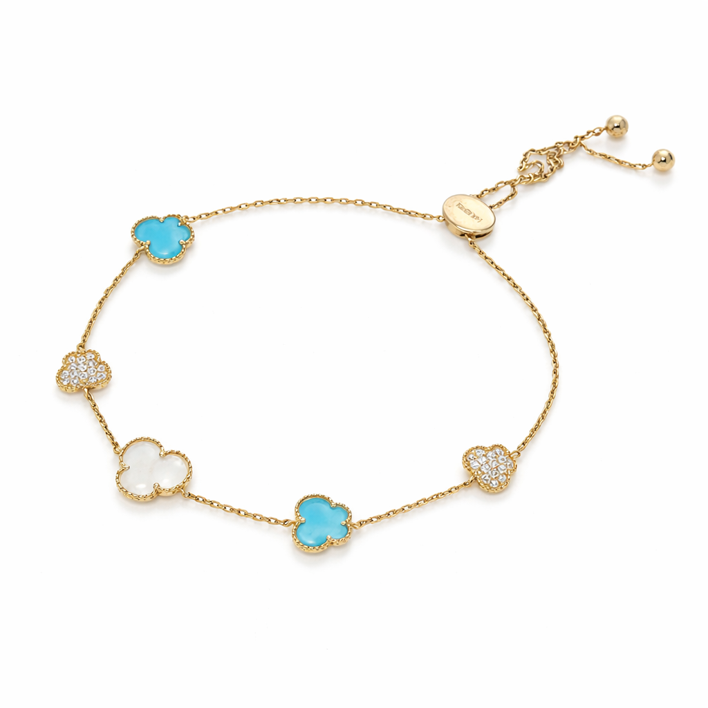 Gold bracelet with turquoise and white stones on a white background