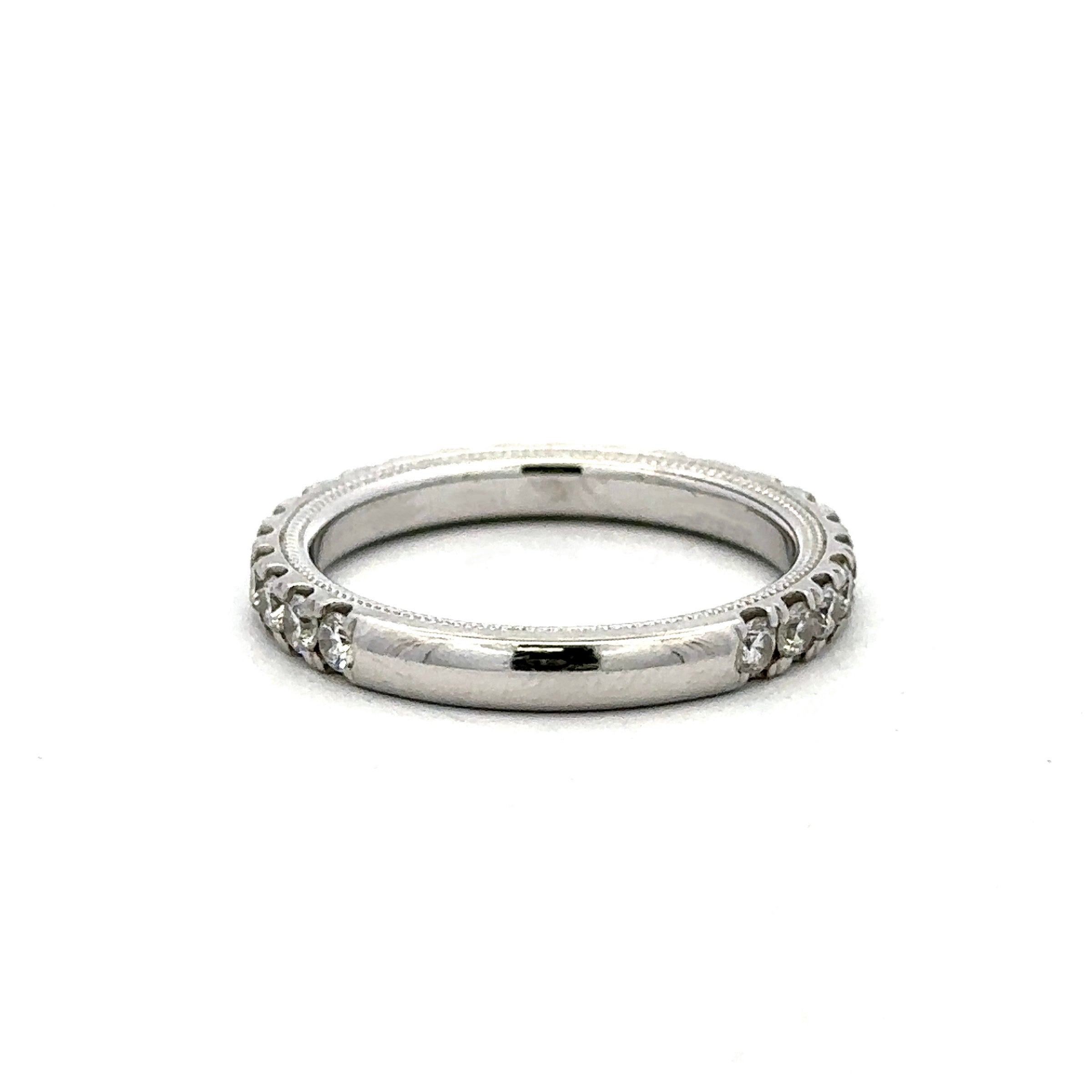 A silver-toned eternity ring featuring a polished center band and a textured, beaded outer band set with small clear stones, shown on a plain white background.