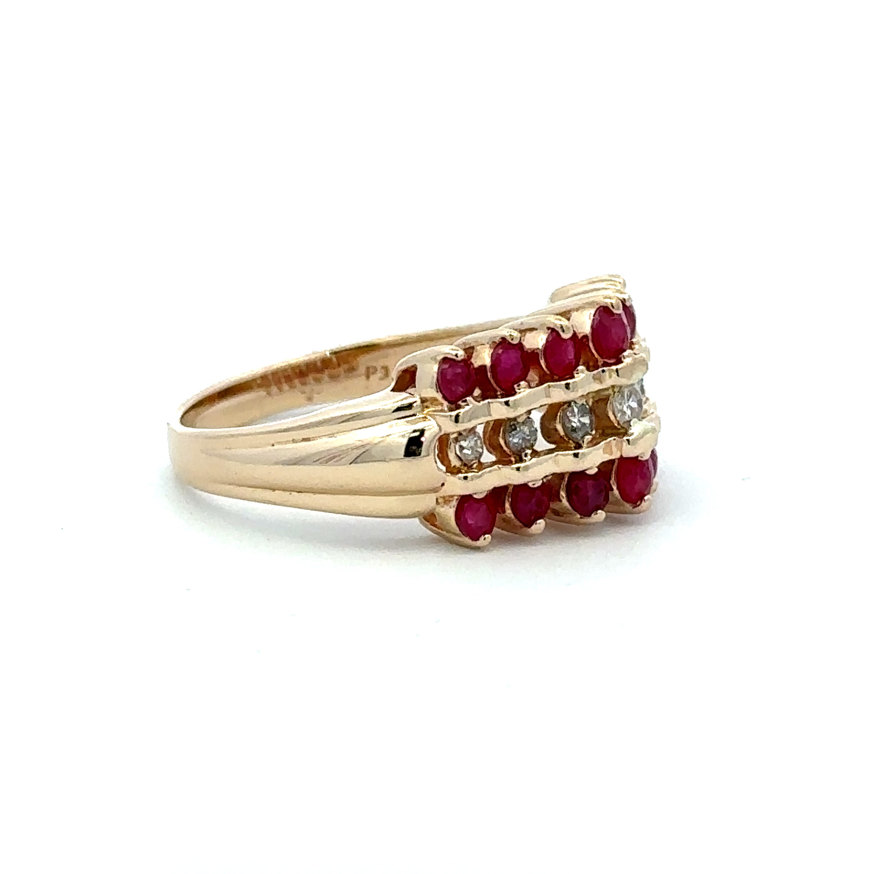 A yellow gold ring featuring three rows of round-cut red gemstones and small clear accent stones, set against a plain white background.