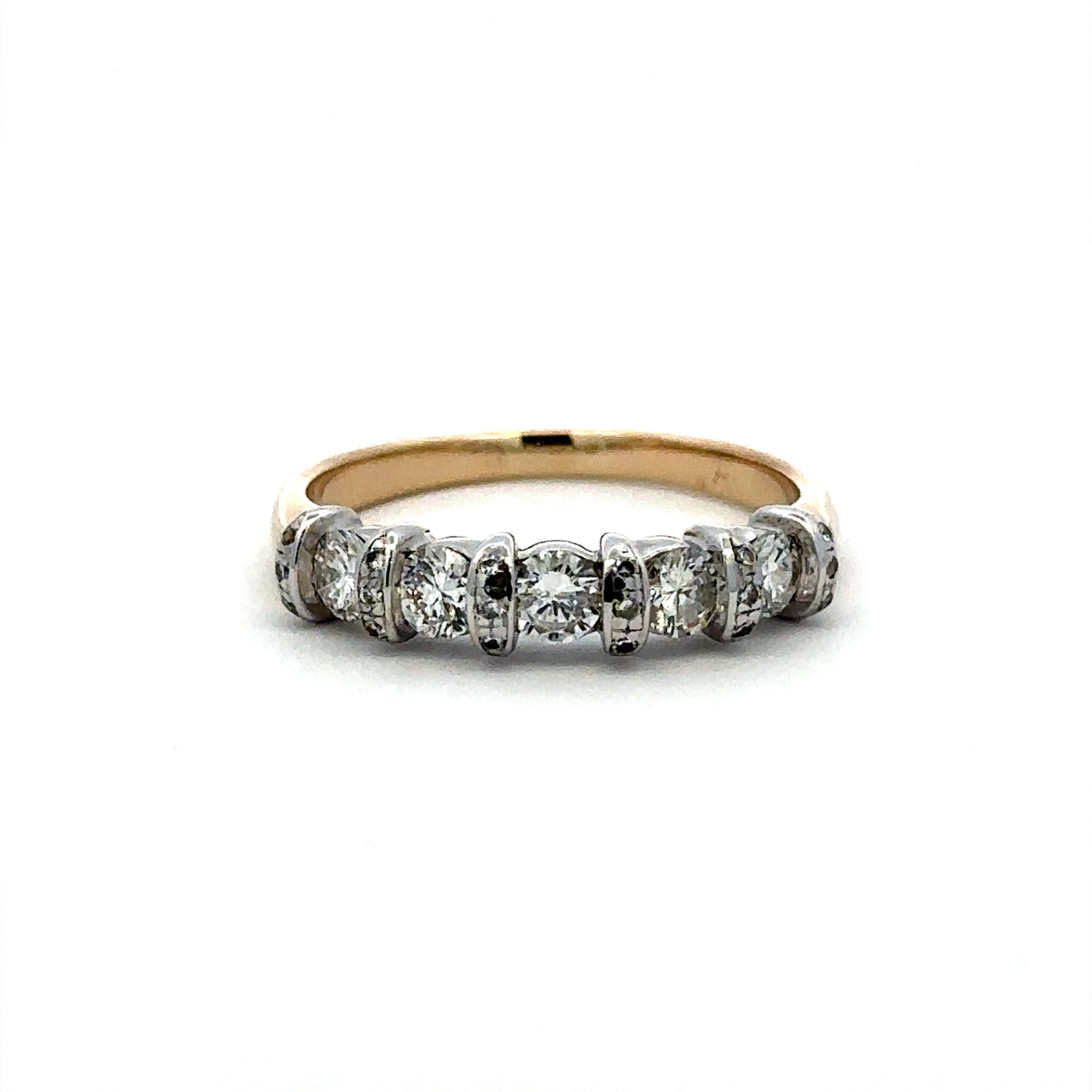A yellow gold diamond band ring featuring five round-cut diamonds set in silver-colored prong settings, shown against a plain white background.
