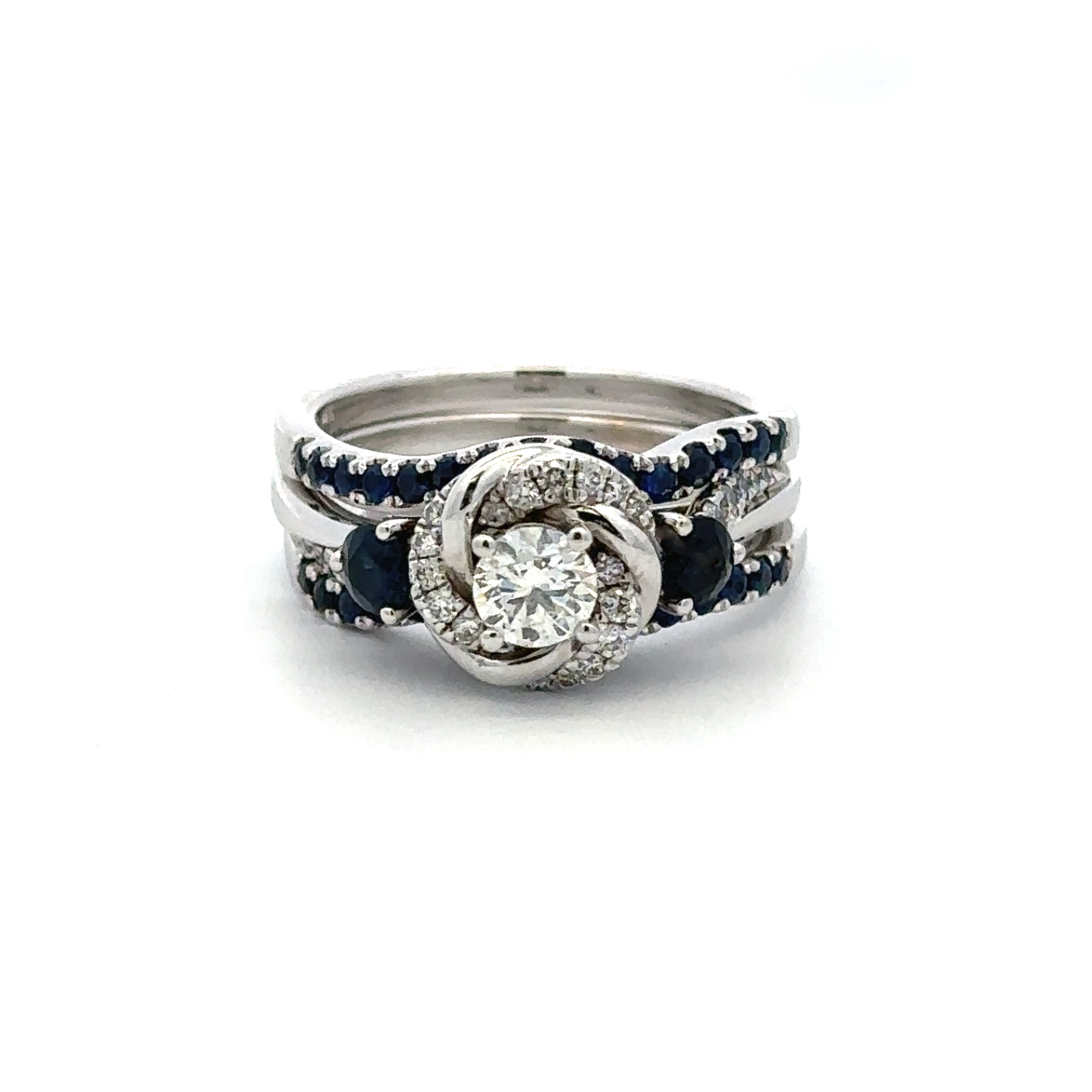 sapphire and diamond ring set on a white background 