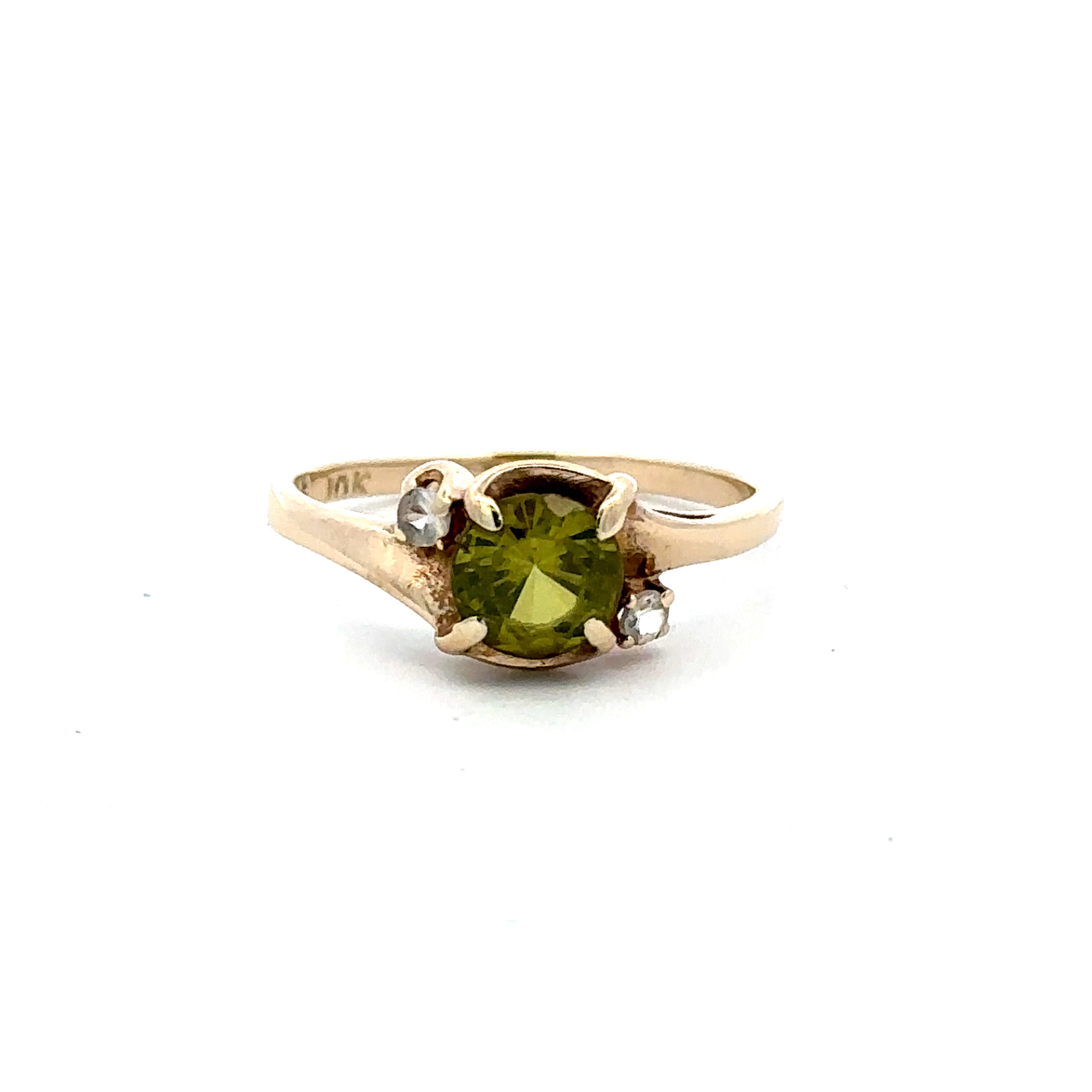 Peridot and CZ accented ring on a white background 