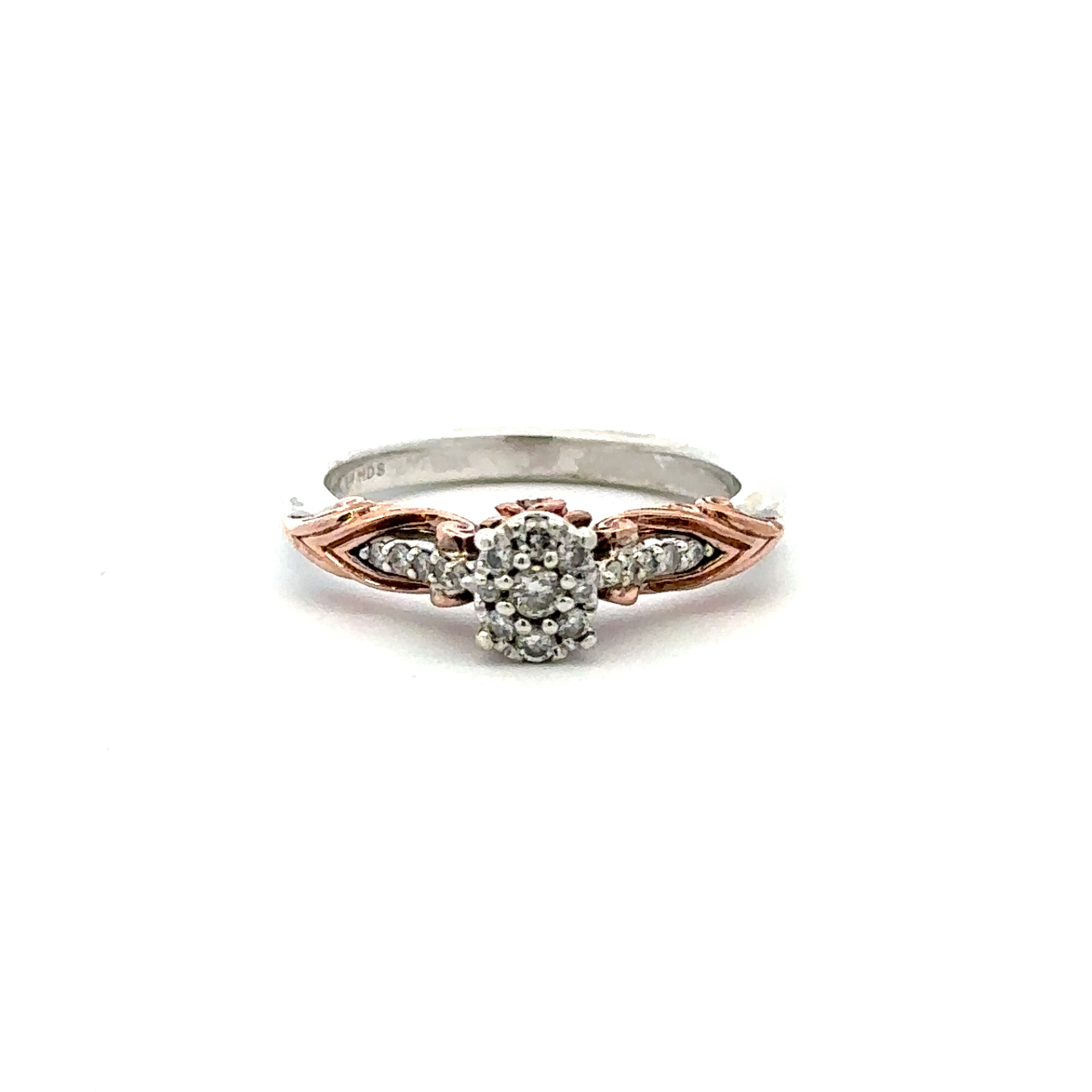 A two-tone diamond ring featuring a rose gold and silver band with a central diamond cluster, set against a plain white background.