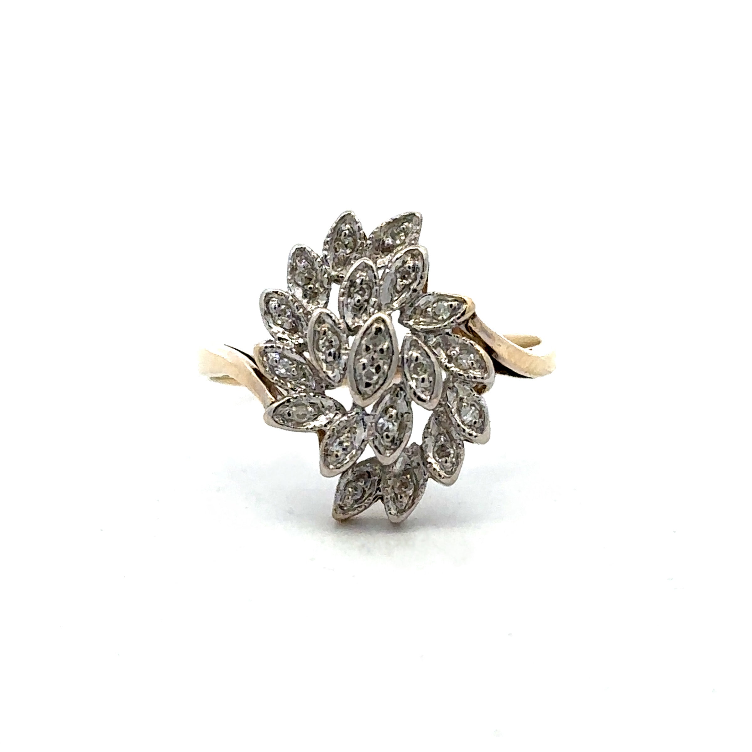 A vintage-style cluster ring featuring marquise and oval-cut clear stones in a silver-toned setting, with a yellow-gold band visible on both sides, photographed against a plain white background.