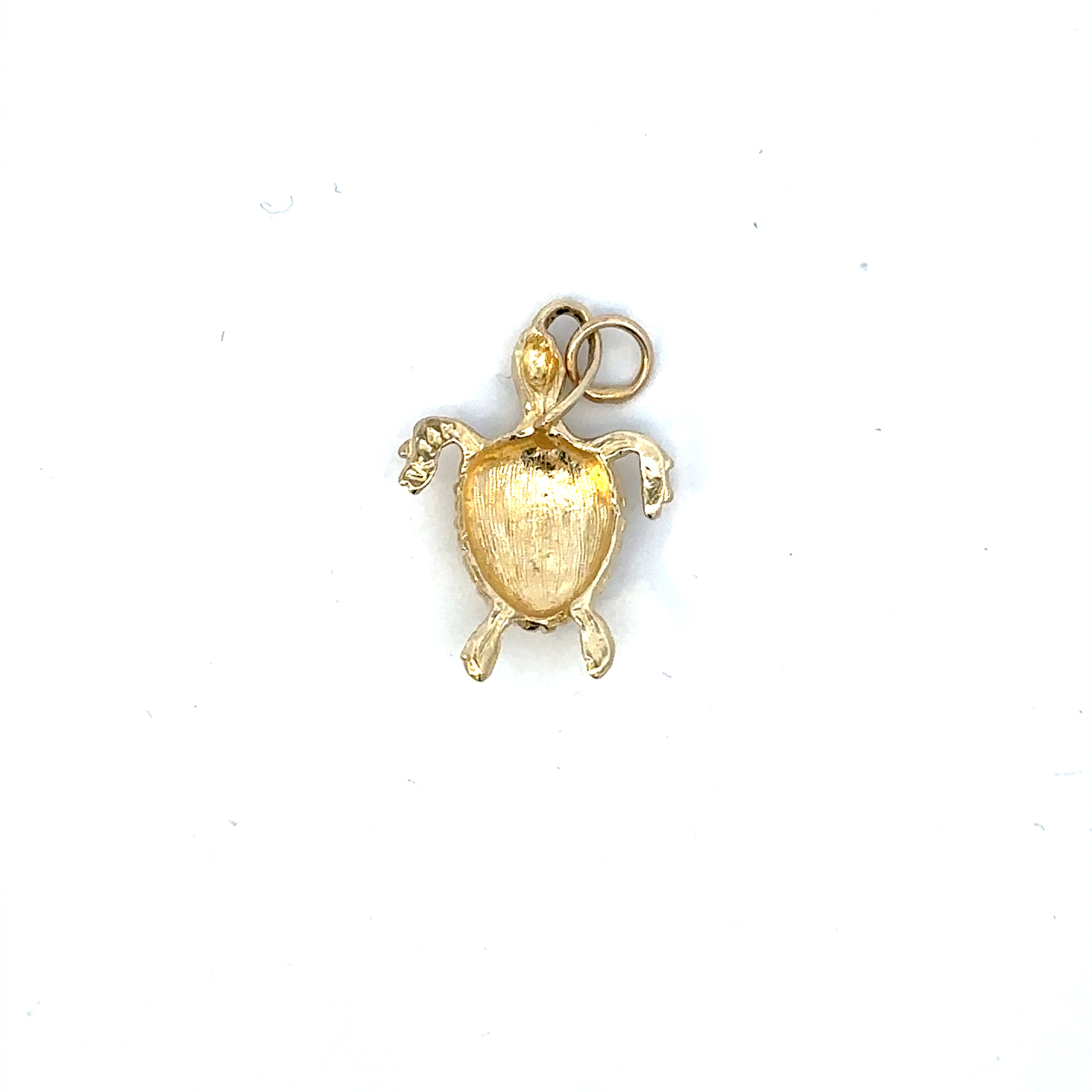Gold turtle pendant on a white background