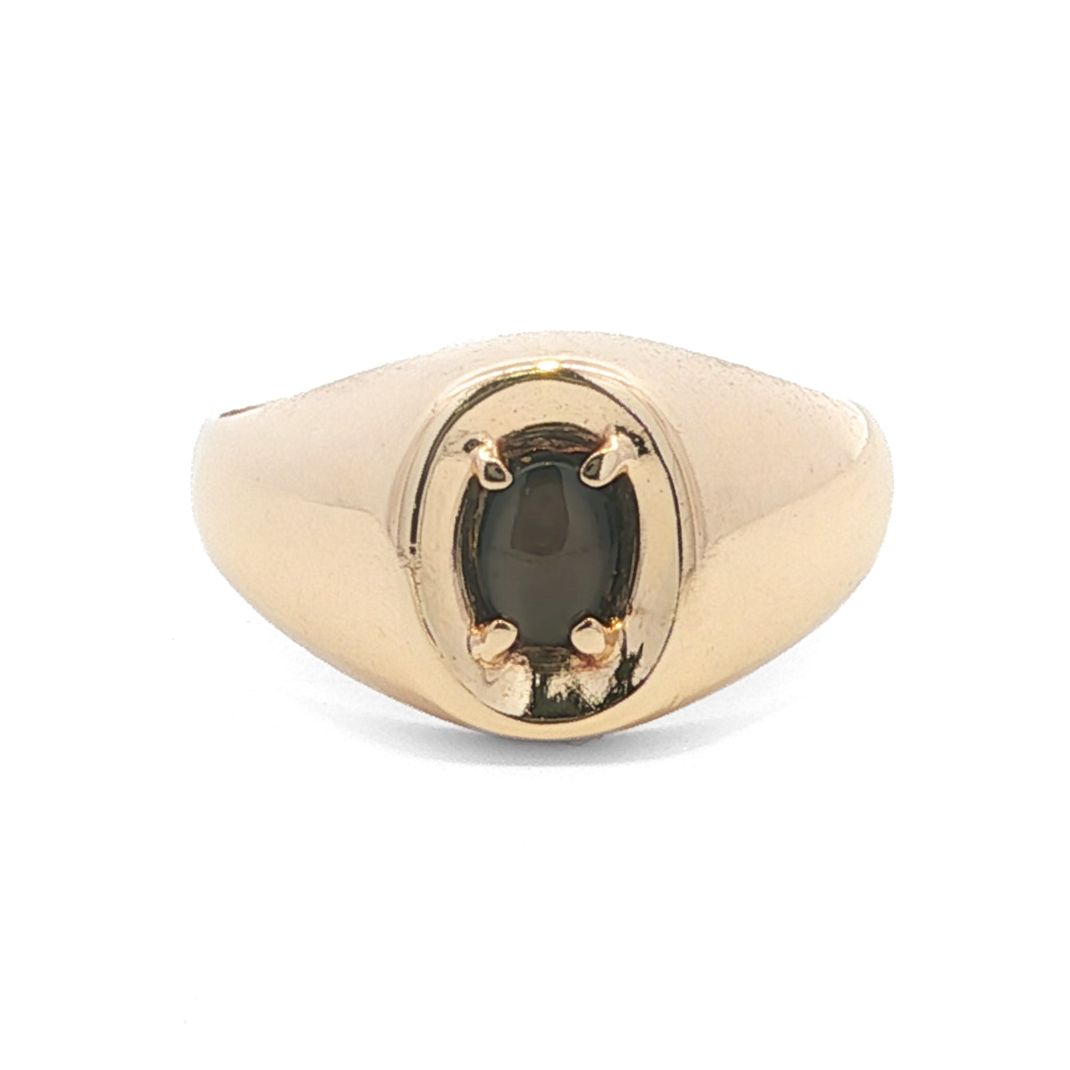 Gold ring with a black gemstone on a white background