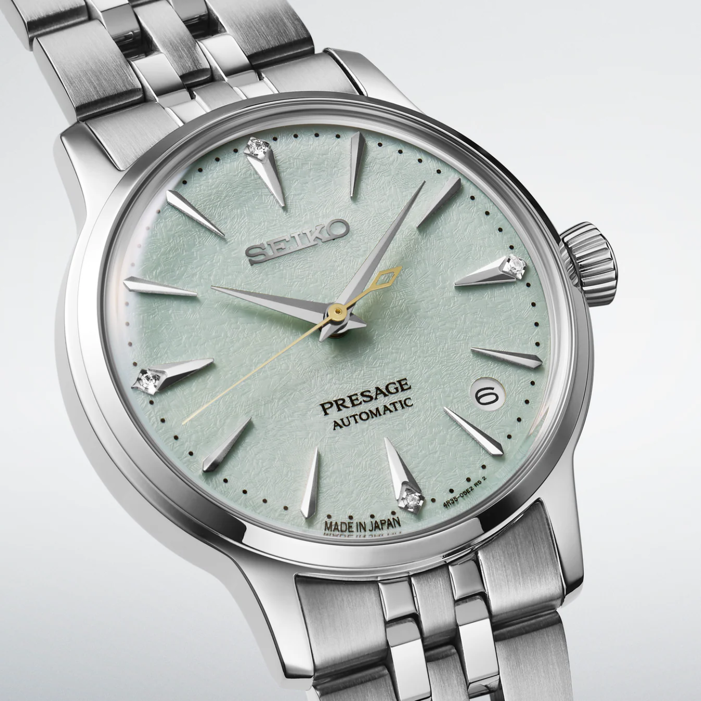 Seiko Presage watch with silver metal bracelet on a light gray background