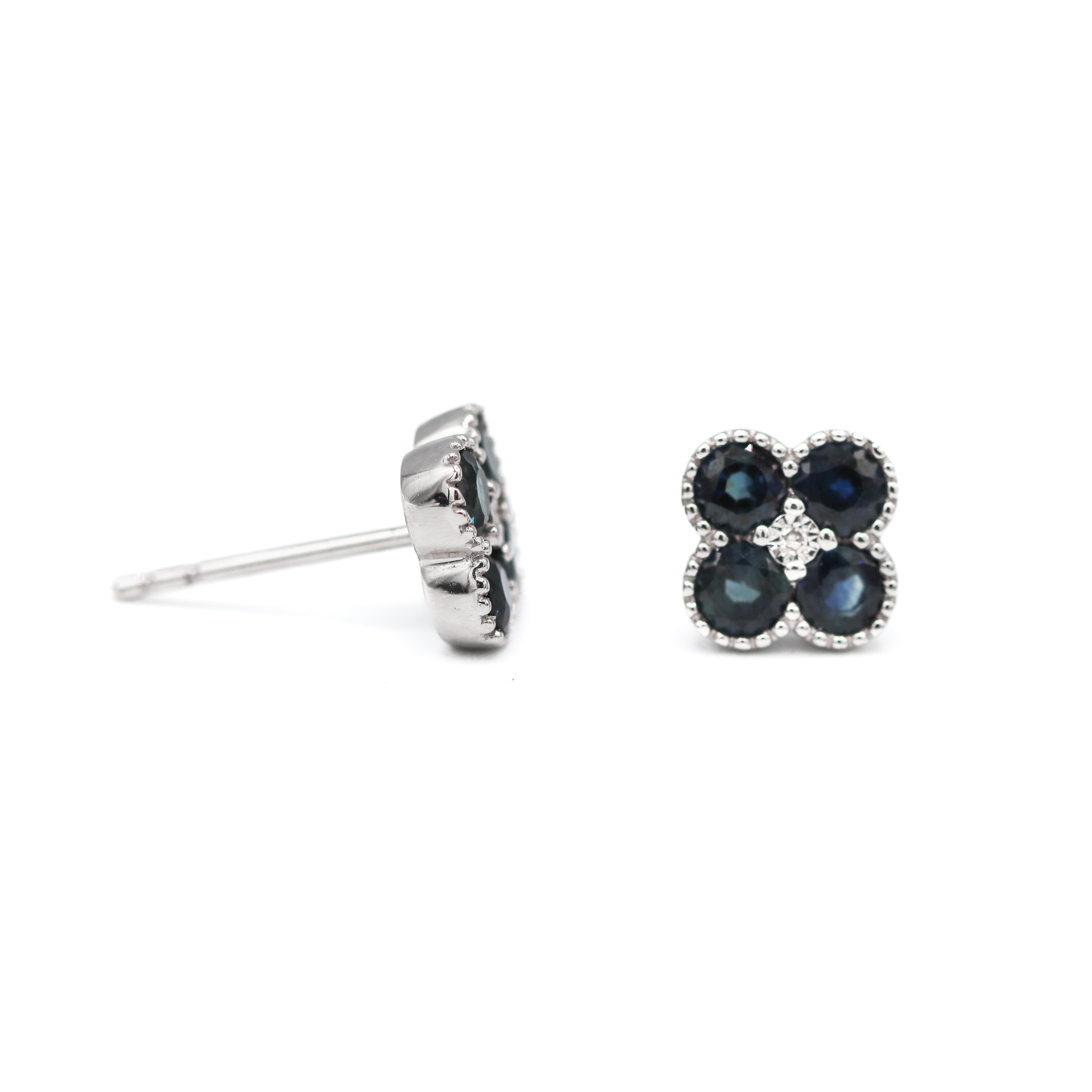 Right front-facing and left side view of 14K White Gold 1CTW. Sapphire & 1/50CTW. Diamond Clover Stud Earrings on a white background.
