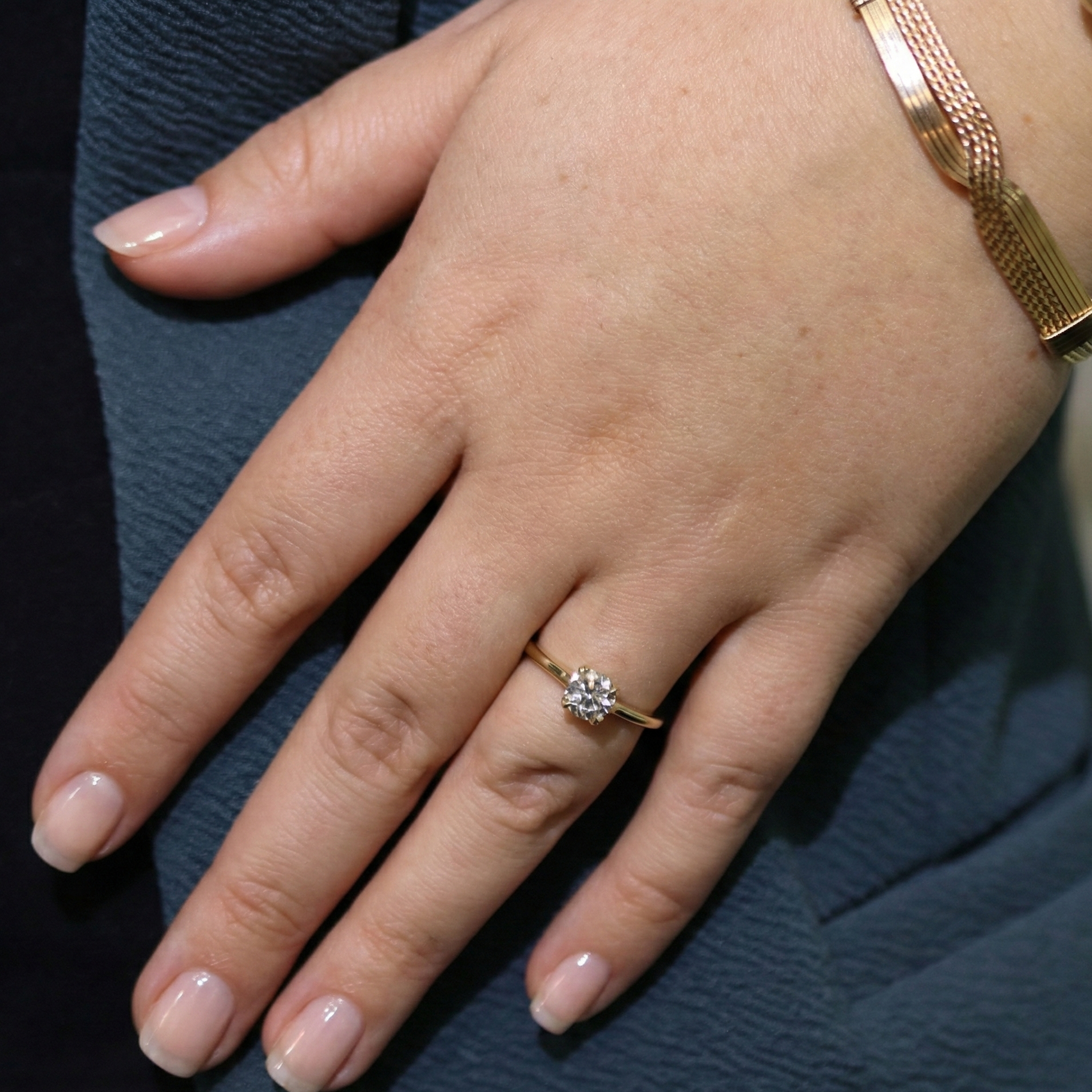 Gold diamond ring modeled on hand 