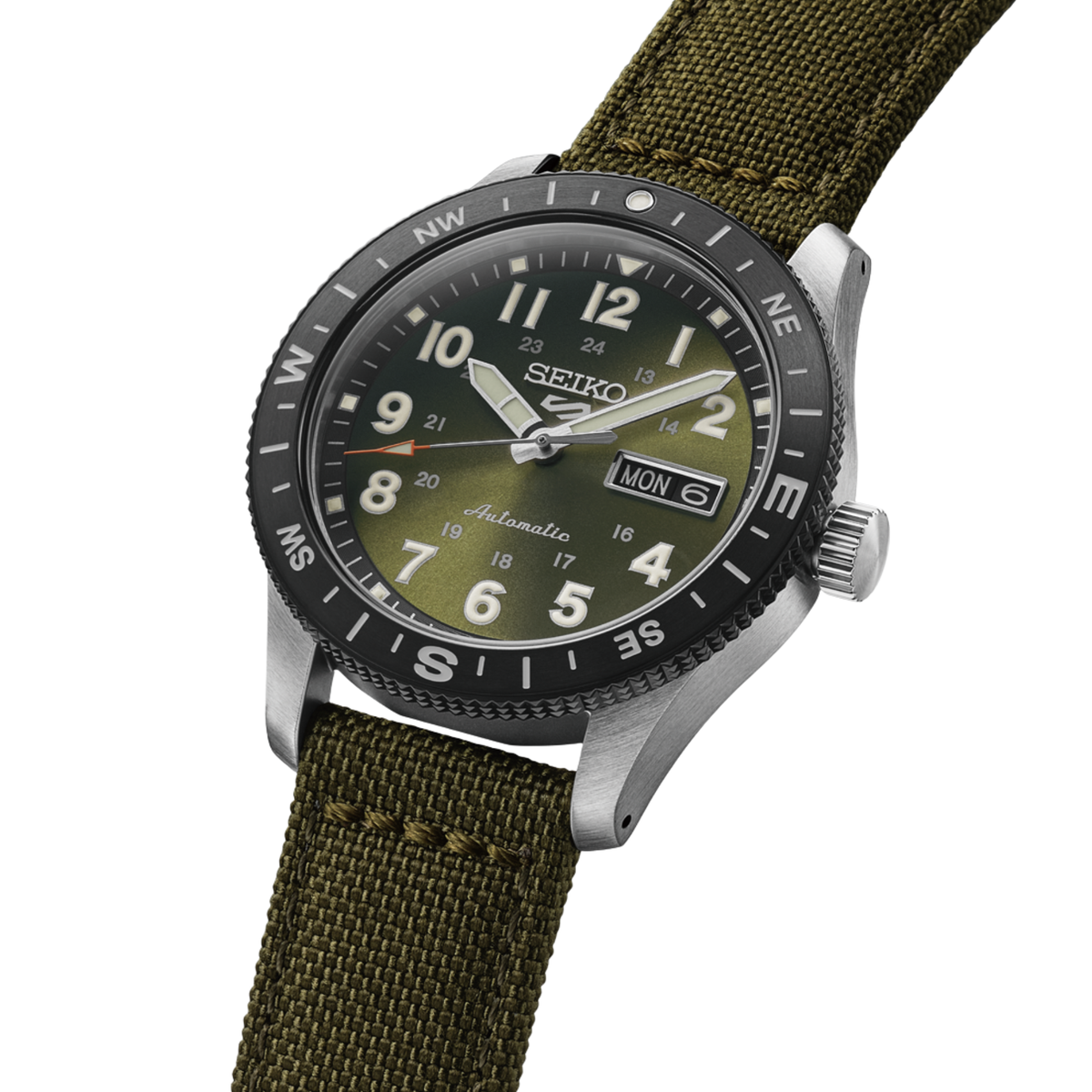 A Seiko automatic watch with an olive green dial, black bezel, and an olive green canvas strap, shown on a plain white background.