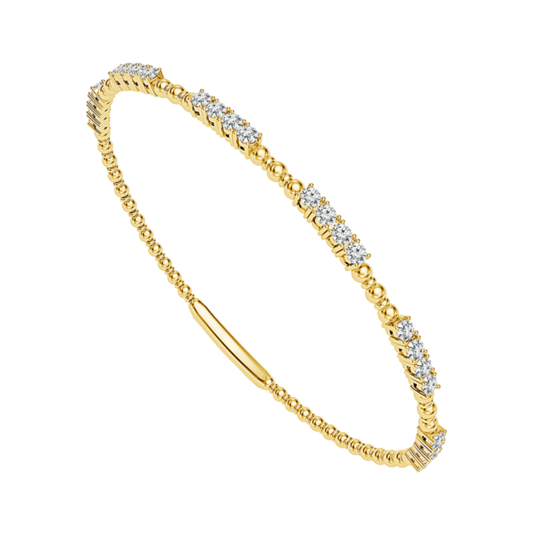 Angled view of 14K Yellow Gold 0.9CTW. Diamond Interspersed Beaded-Design Flexi Bangle Bracelet on white background.