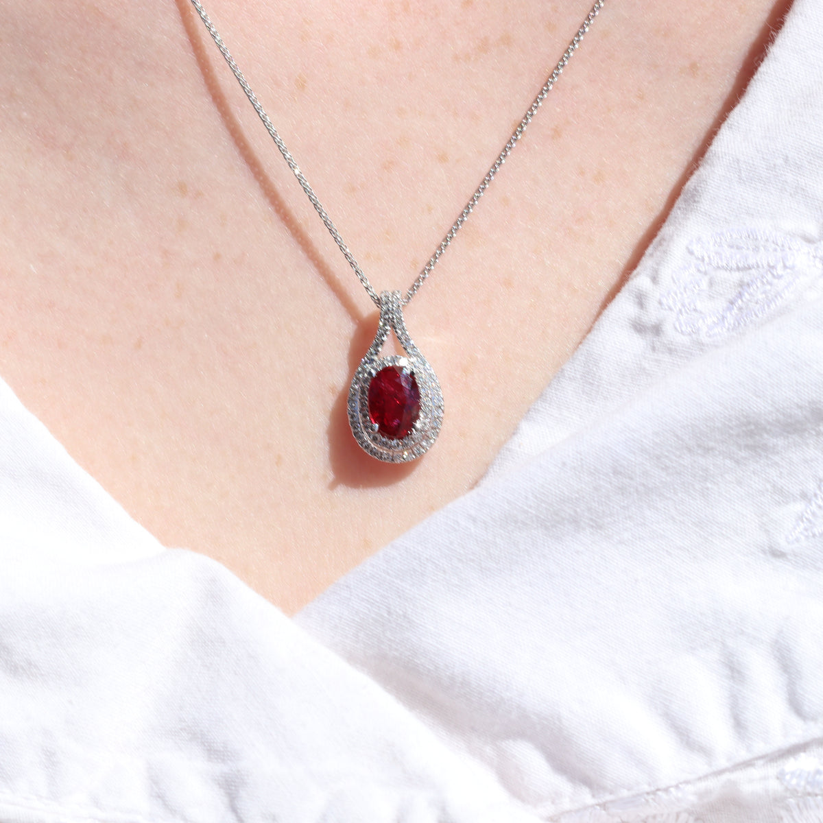 18K White Gold 1.50CT. Oval Ruby and 0.29CTW. Diamond Halo Pendant On A 14K White Gold  Chain