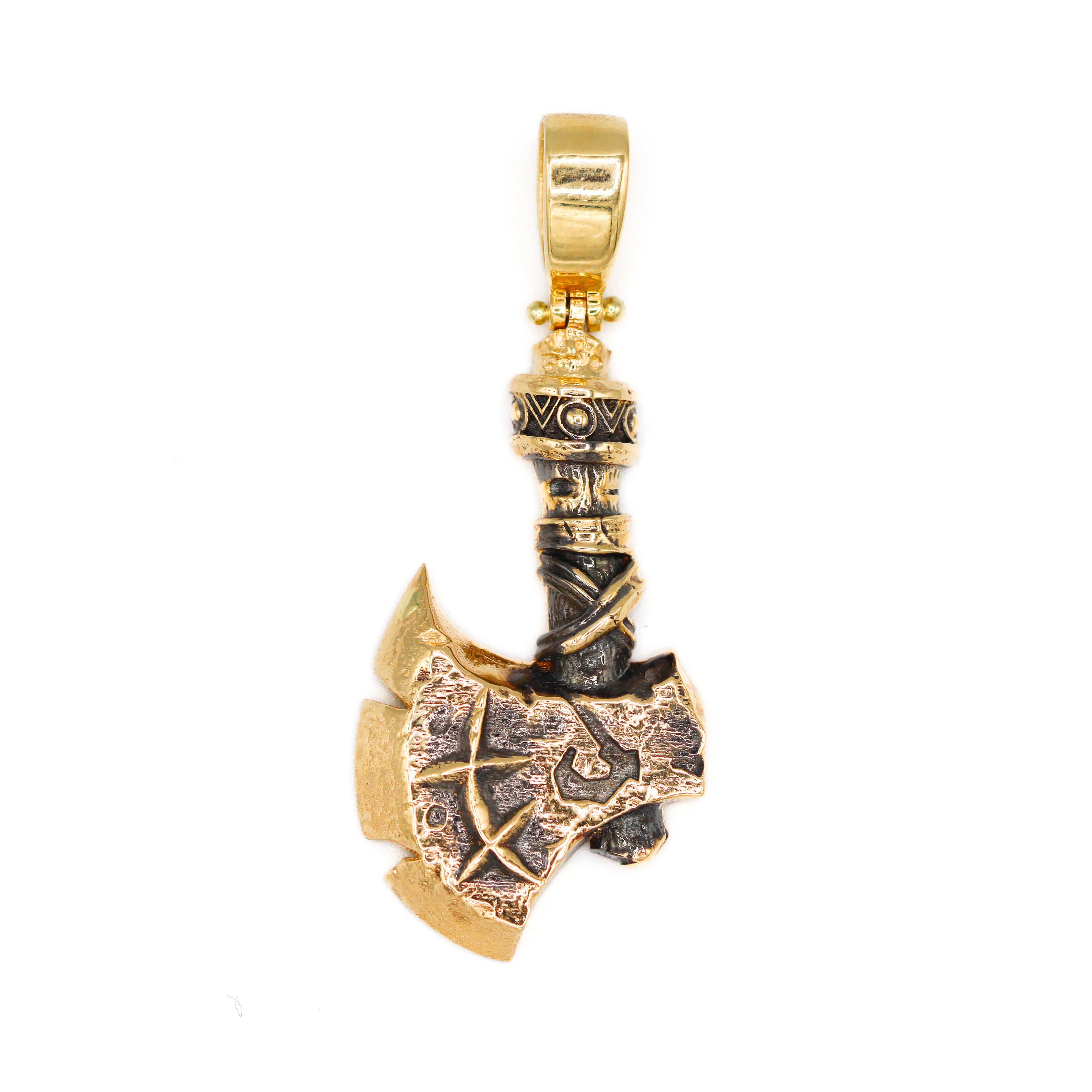 Close up of antiqued gold hatchet pendant