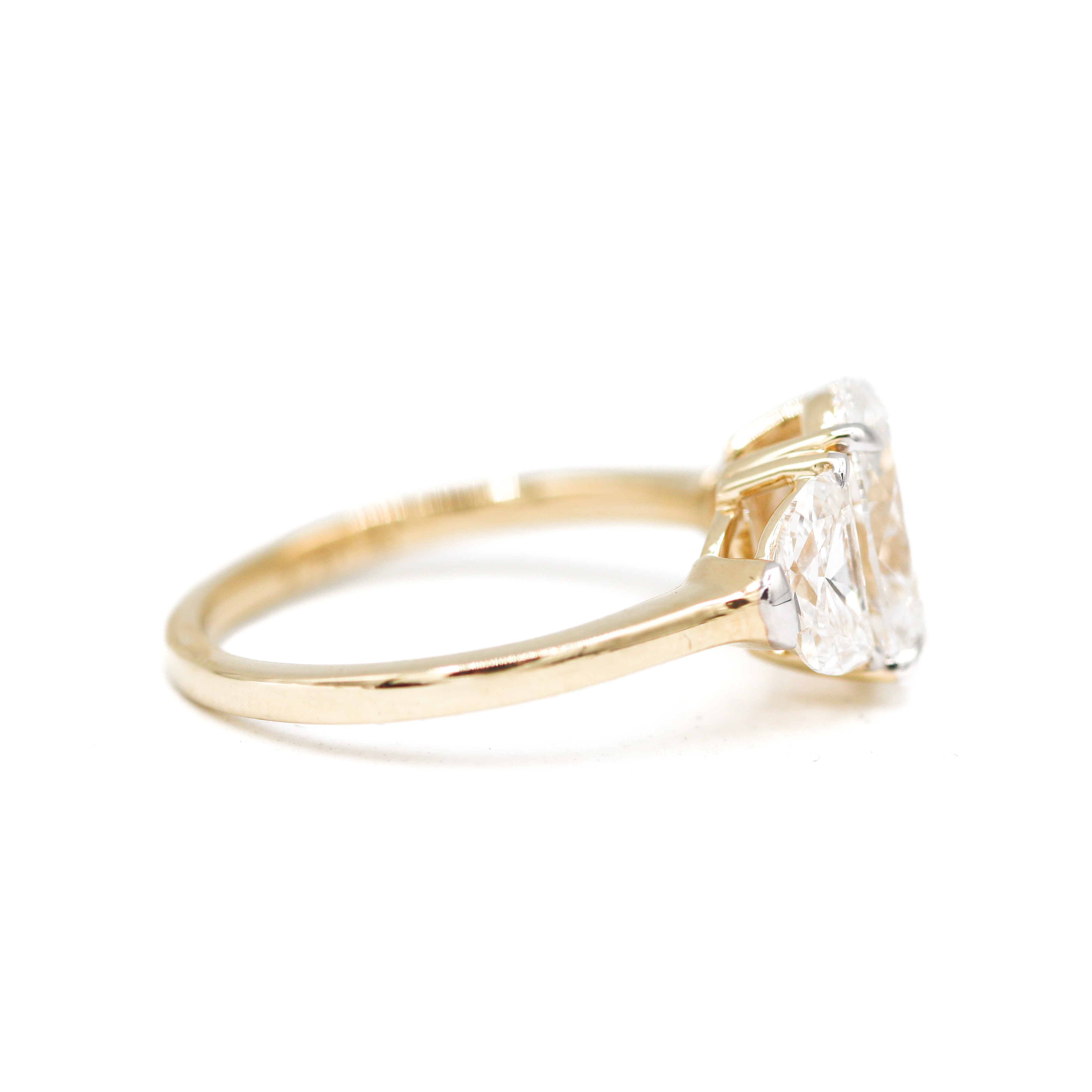 Right Side View of 2 Carat Oval Diamond Yellow Gold Ring with Half-Moon Diamonds on either side.