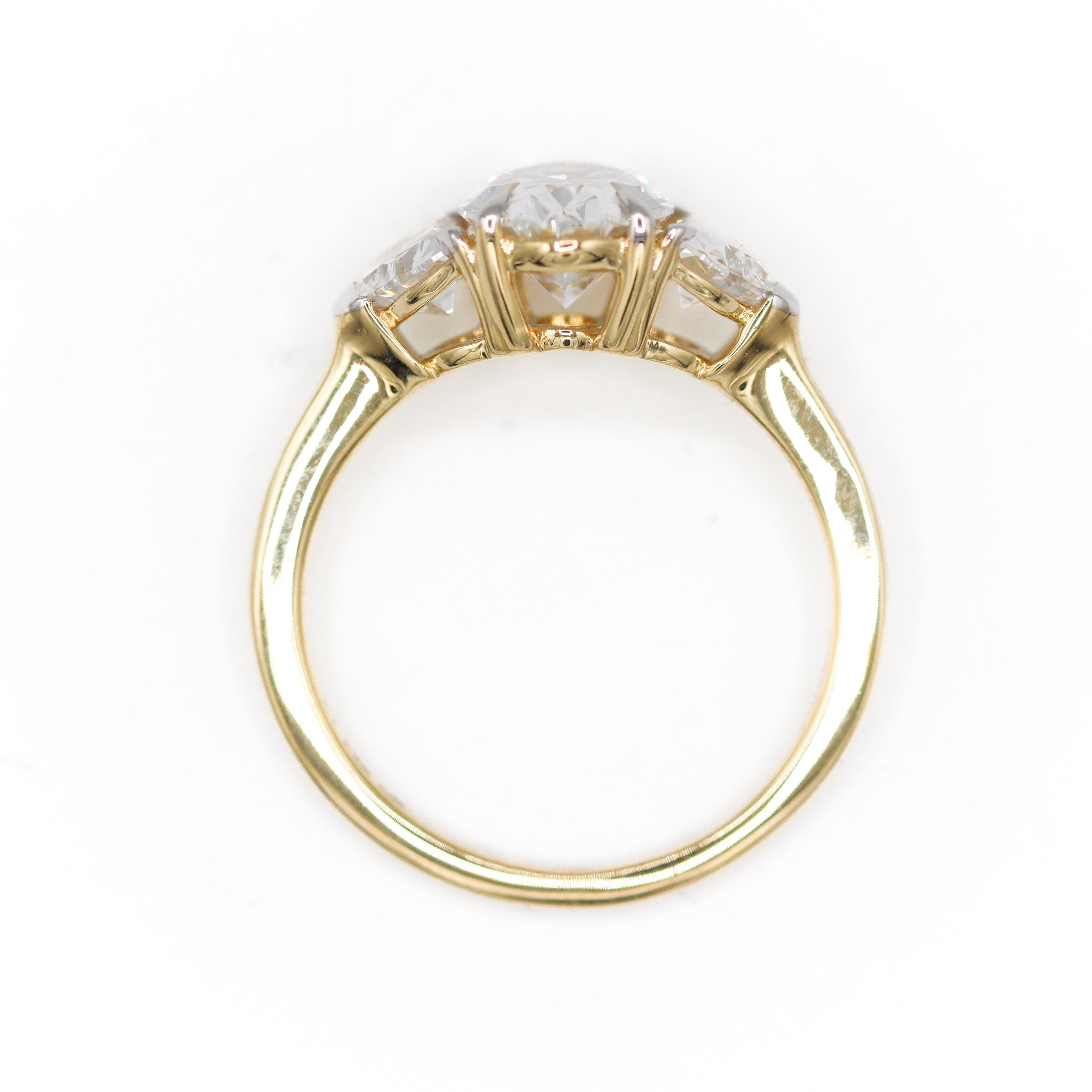 Side View of 2 Carat Oval Diamond Yellow Gold Ring with Half-Moon Diamonds on either side.