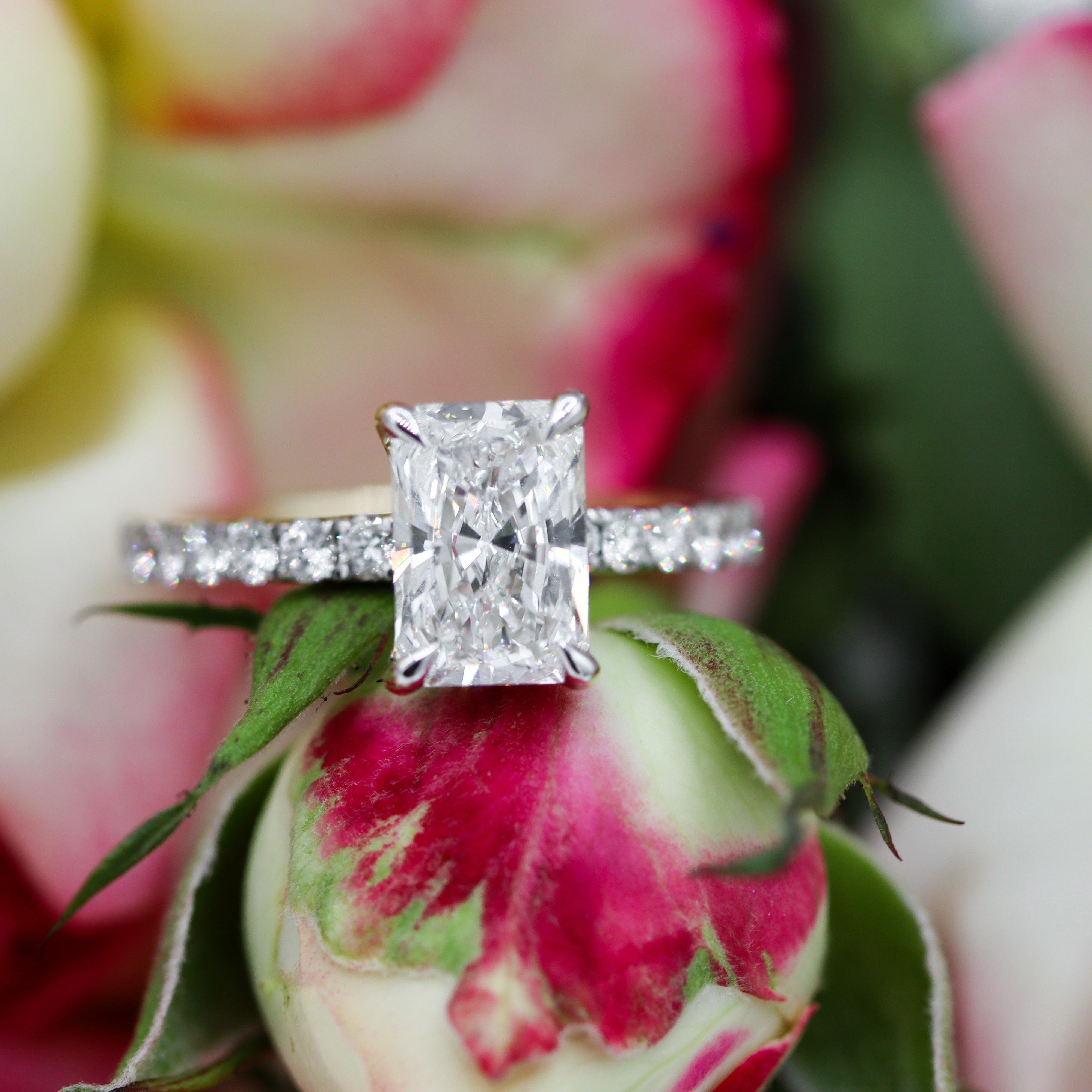 14K Yellow Gold Radiant-Cut Lab-Grown Diamond Accent Engagement Ring on a flower