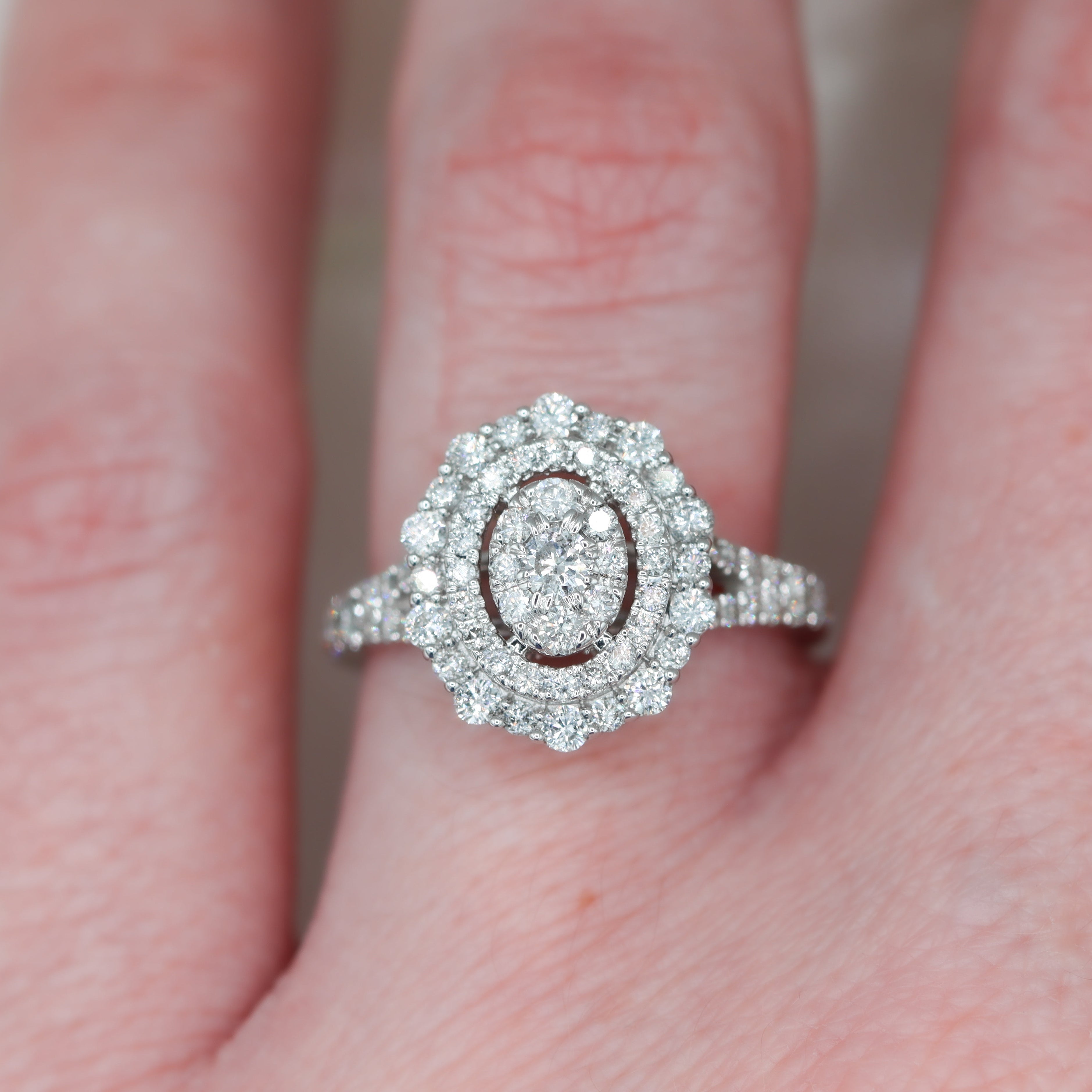 14K White Gold Vera Wang 1CTW. Diamond Tiered Double-Halo Oval Engagement Ring on a hand