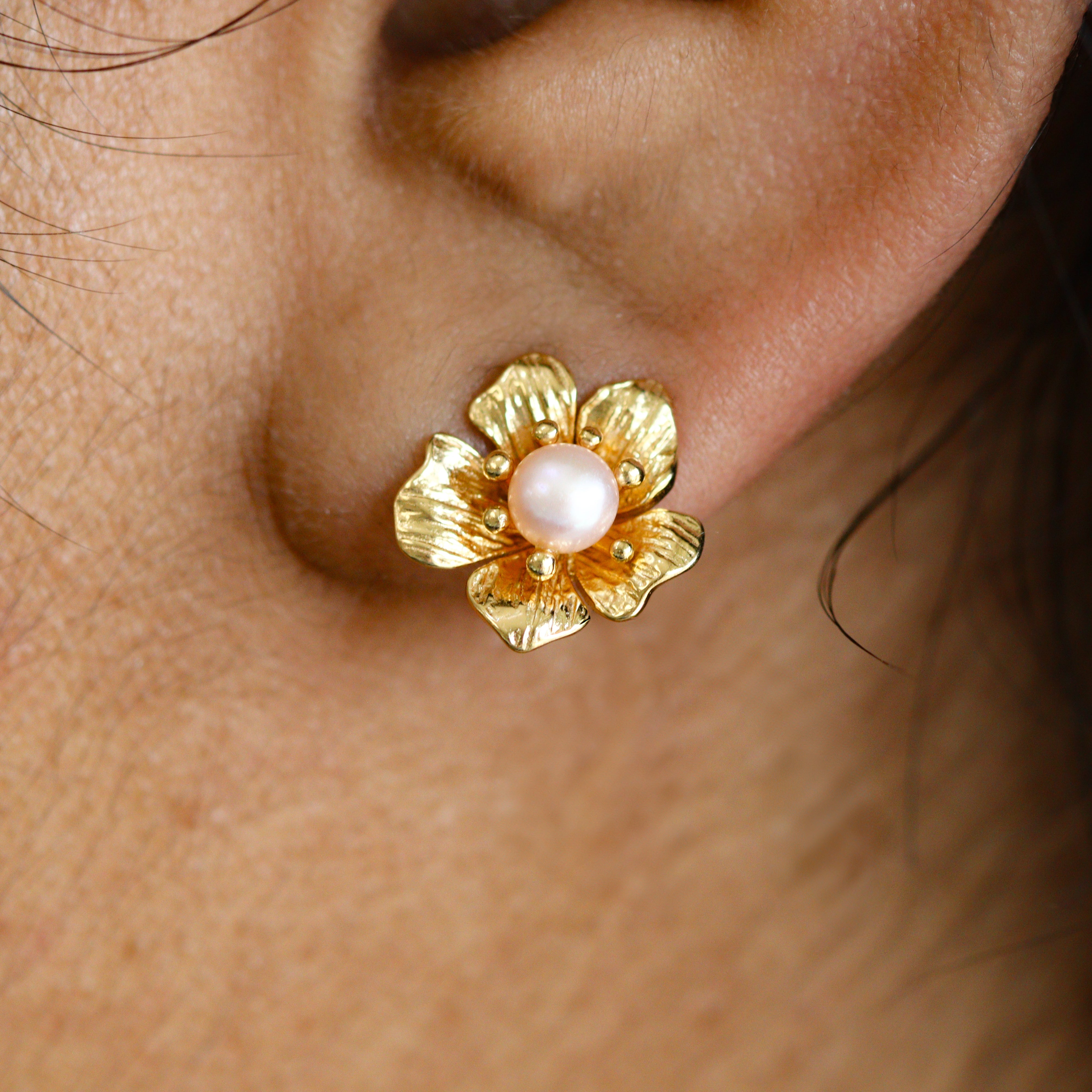 Gold-Plated Flower & Freshwater Pearl Stud Earring on a model