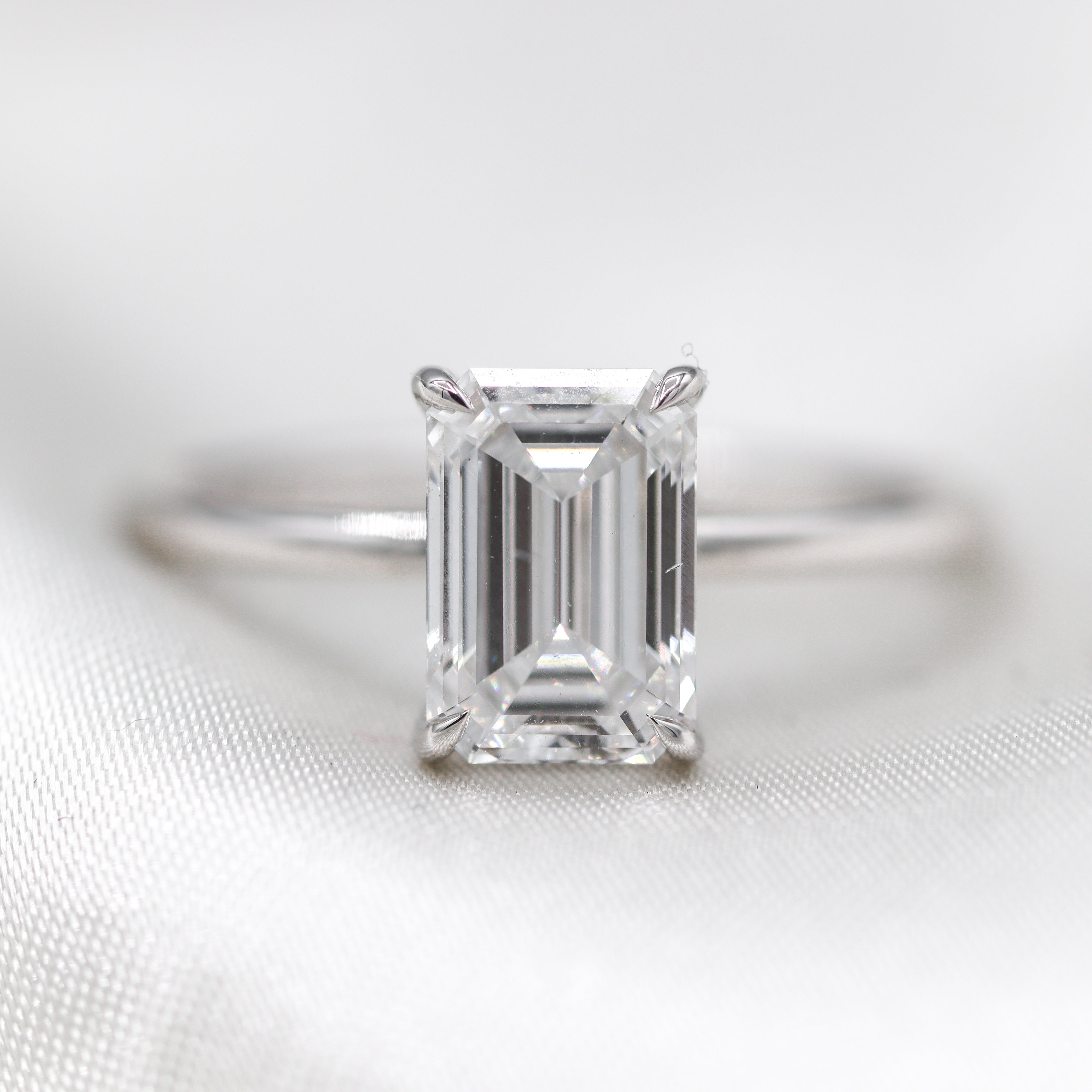 Photo of 14K White Gold 2CT. Emerald-Cut Lab-Grown Diamond Engagement Ring with hidden halo on satin