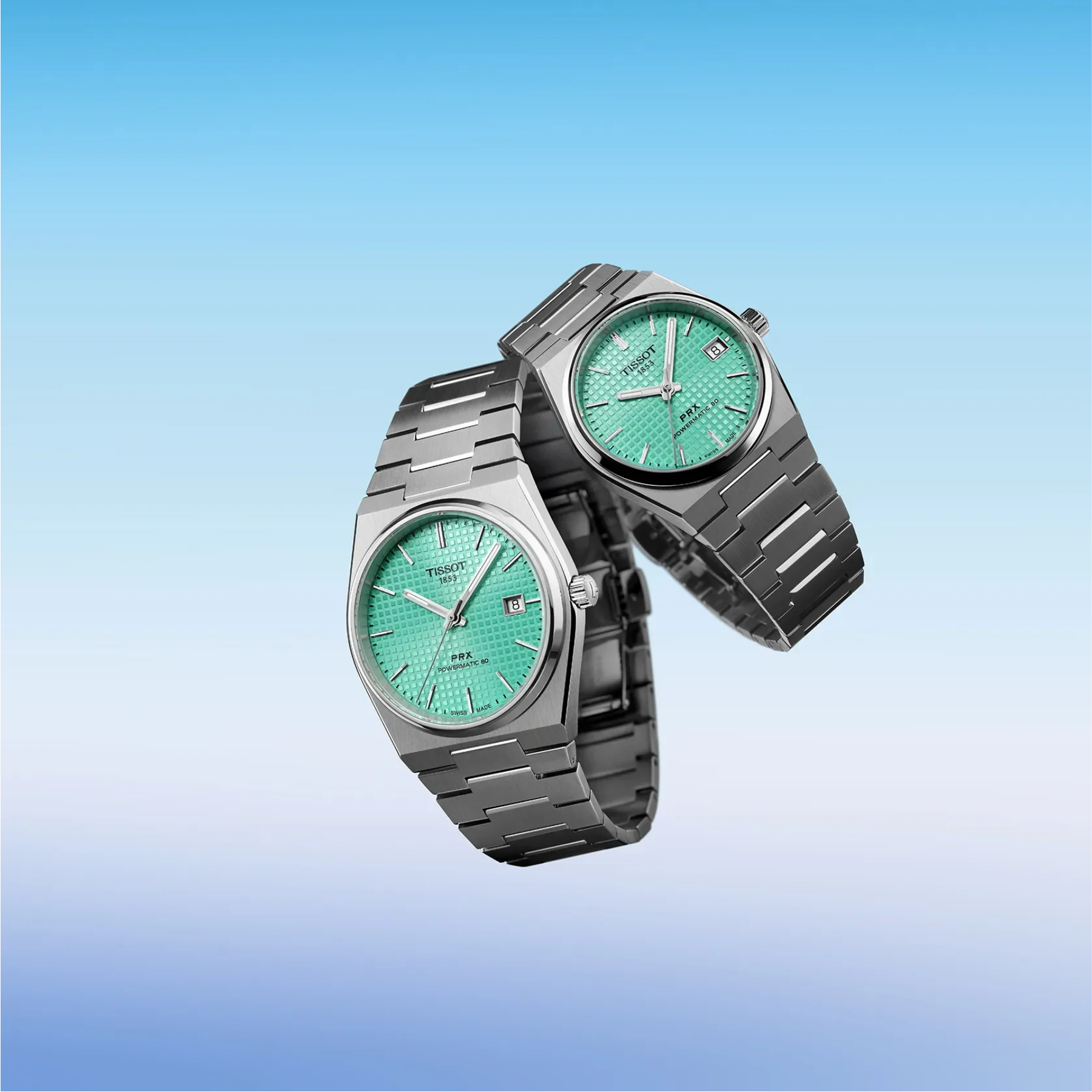 Two wristwatches with silver-tone metal bracelets and green textured dials, floating against a soft blue gradient background.