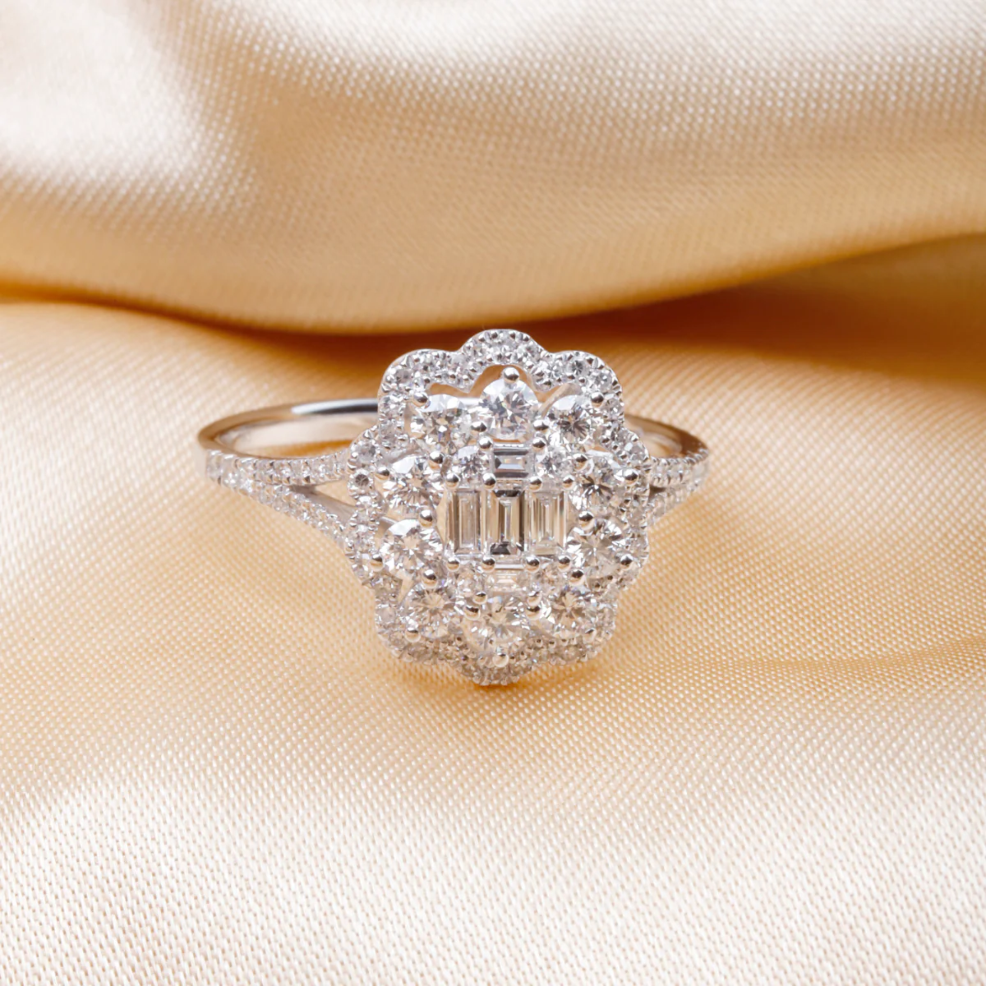 Silver ring with diamond accents on a beige fabric background