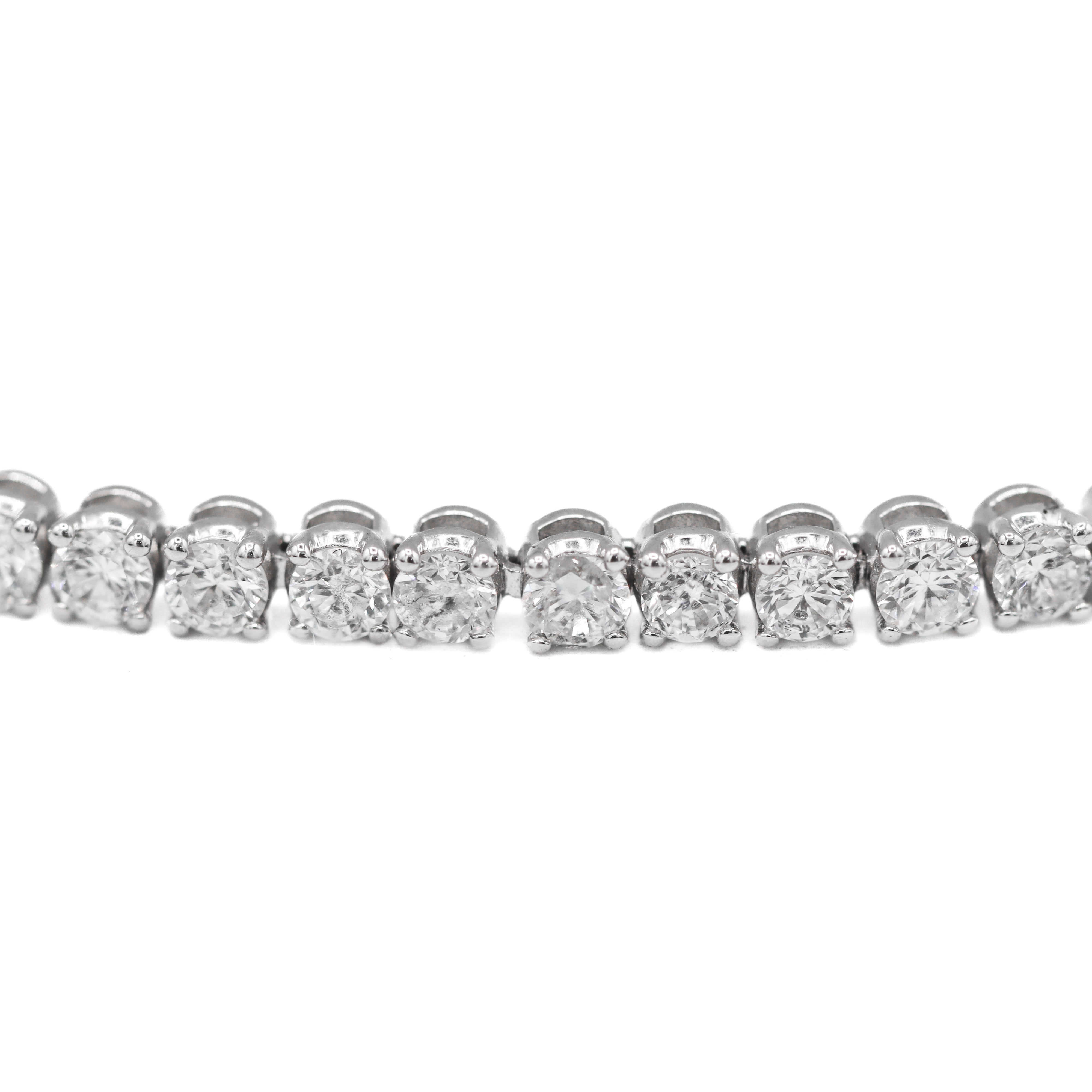 Close up view of the links of this 14K White Gold 4CTW. Lab-Grown Diamond Tennis Bracelet on a white background.