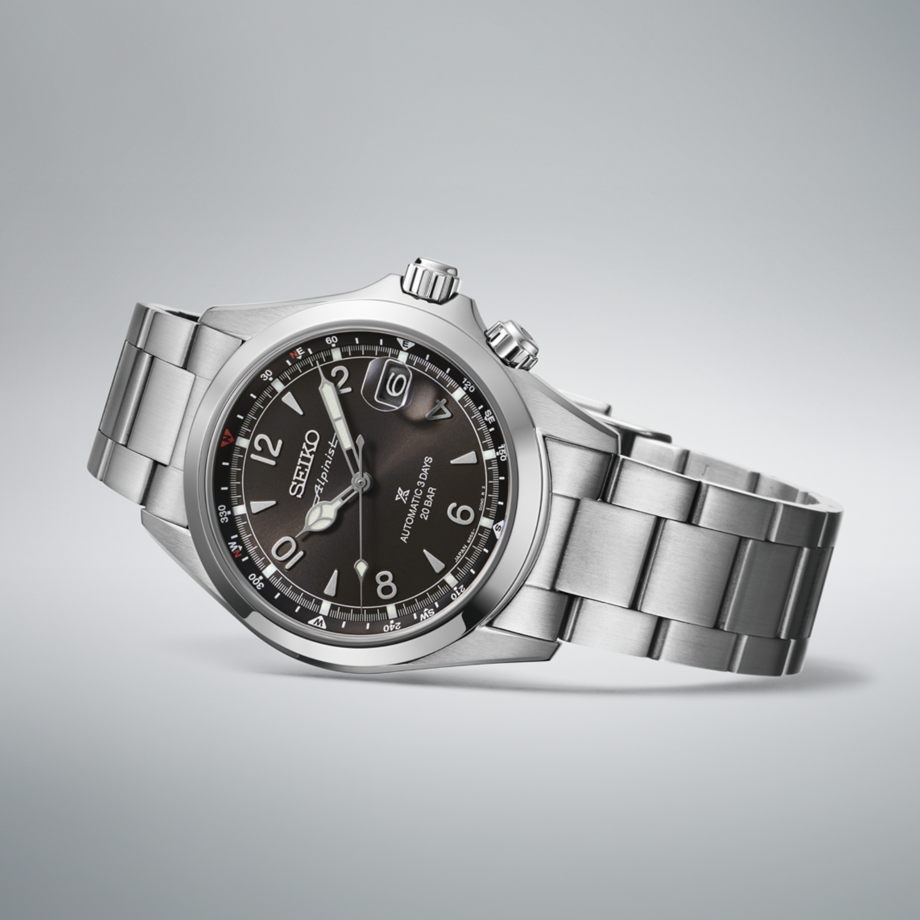 Silver Seiko watch with a dark face on a light gray background