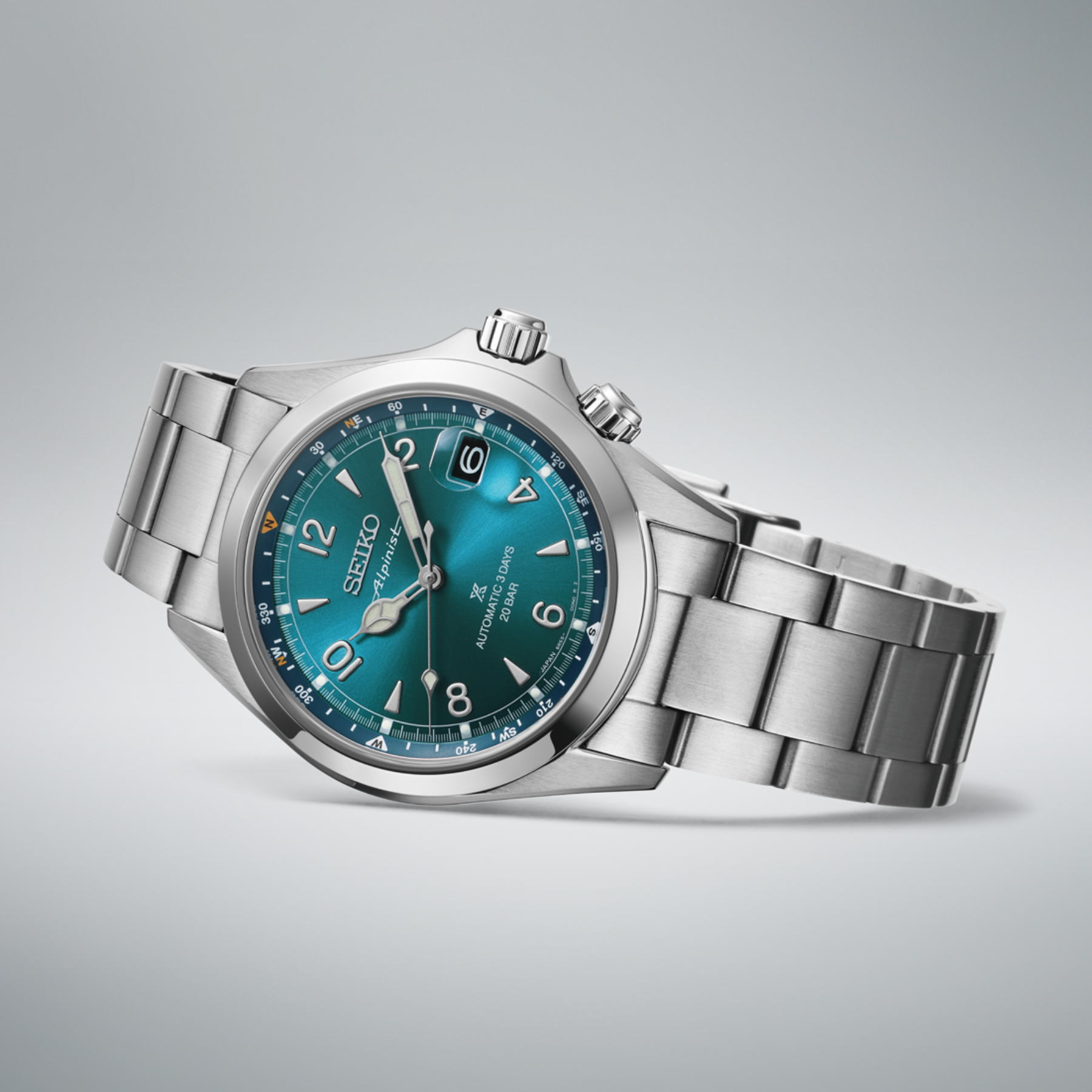 Silver Seiko watch with a blue face on a gray background