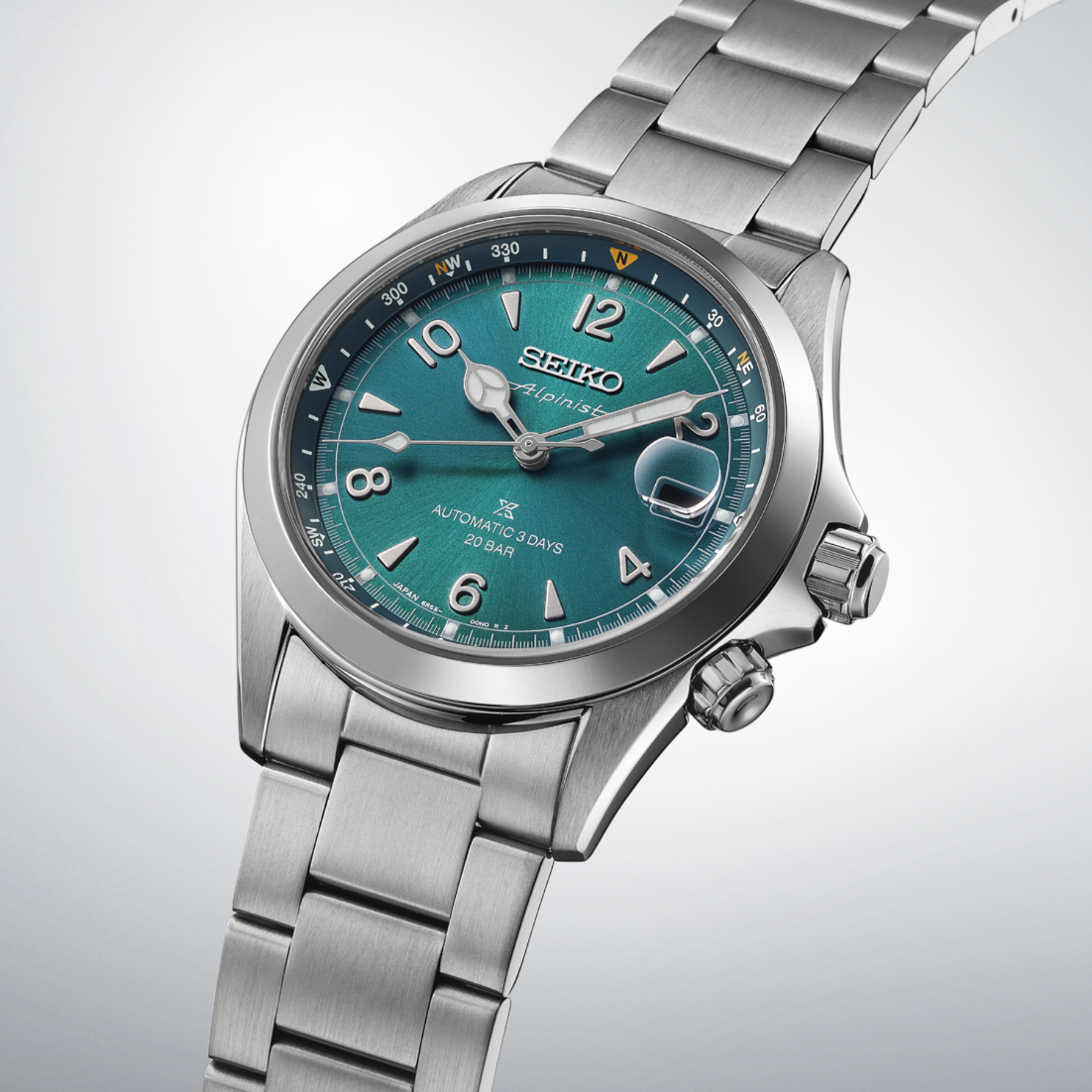 Silver Seiko watch with a blue face on a light gray background