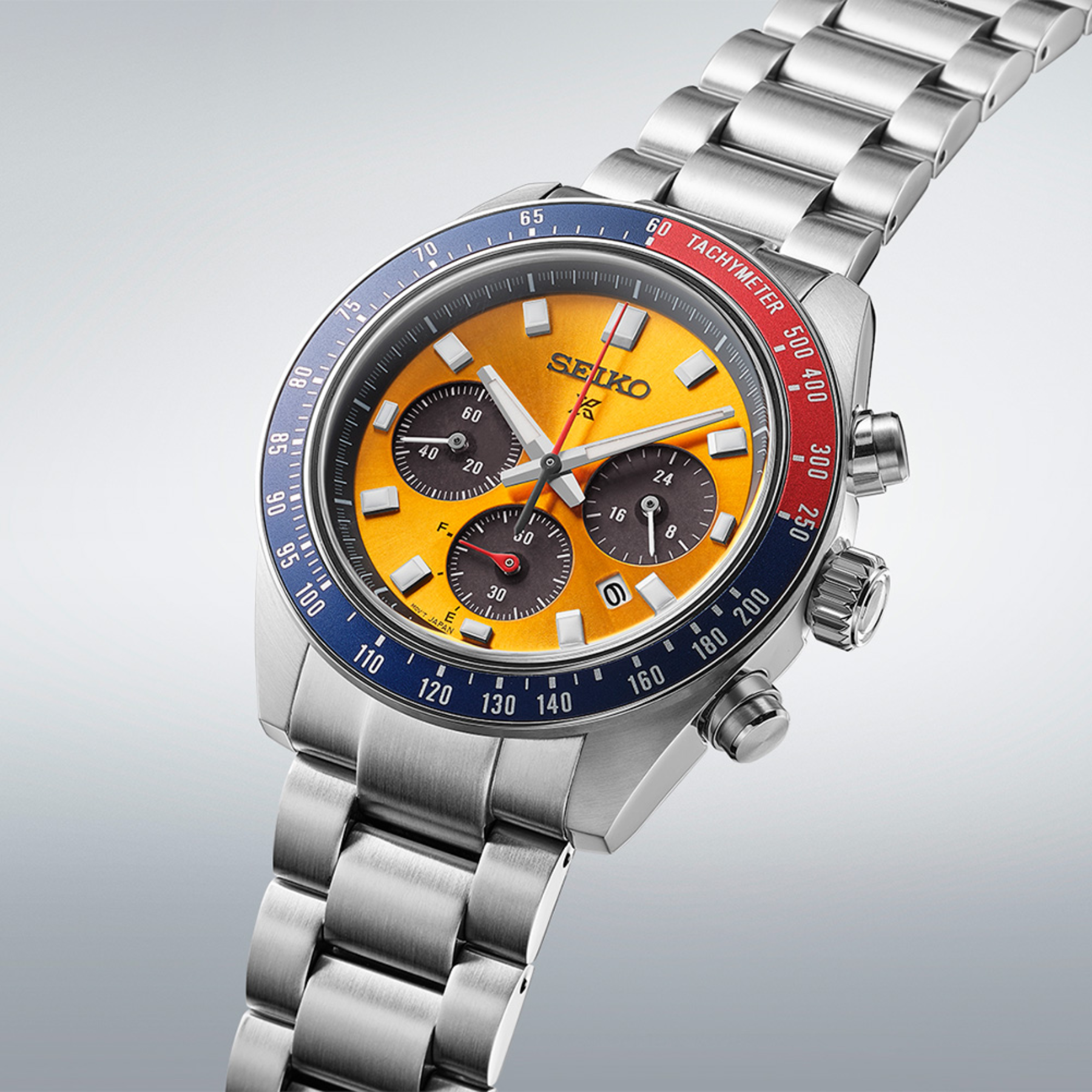 Seiko watch with a silver bracelet and colorful dial on a light gray background