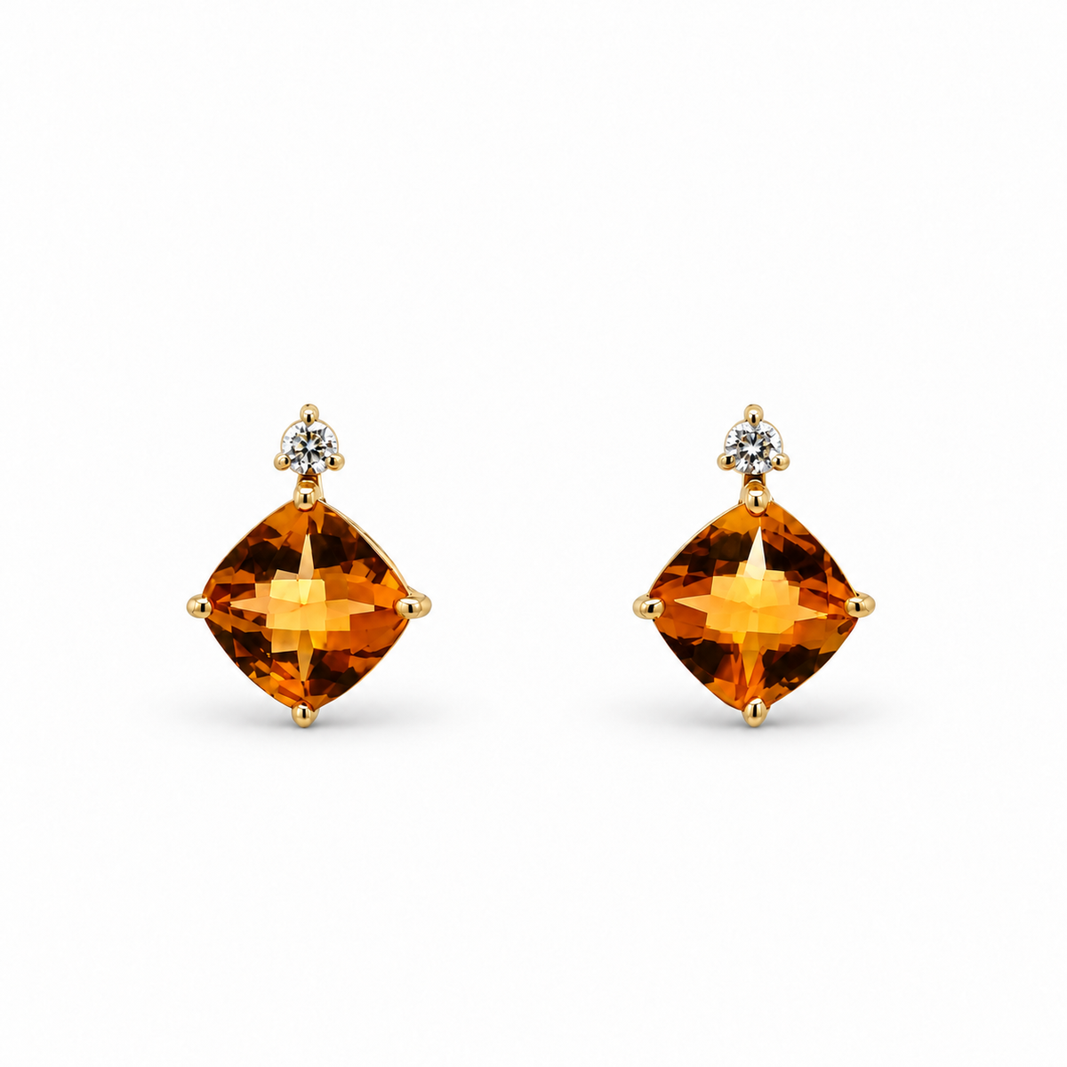Front view of 14K yellow gold earrings with cushion-shaped citrines and round diamond accents on a white background.