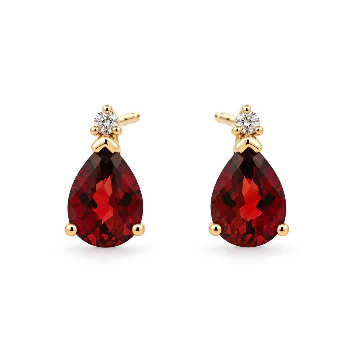 Front view of 14K yellow gold pear-shaped garnet and diamond stud earrings on a white background
