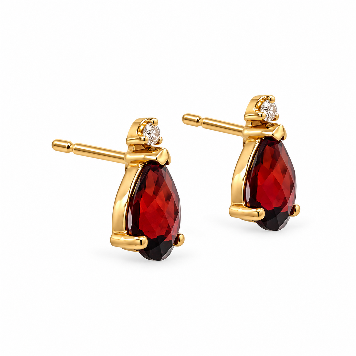 Side view of 14K yellow gold pear-shaped garnet and diamond stud earrings on a white background