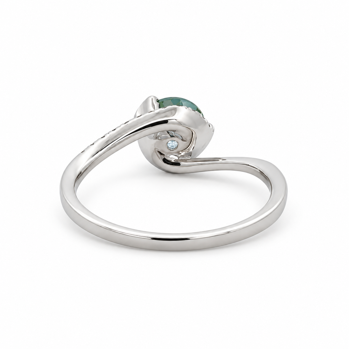 Back view of a 14K white gold green sapphire ring showing the curved bypass band and underside of the center setting.