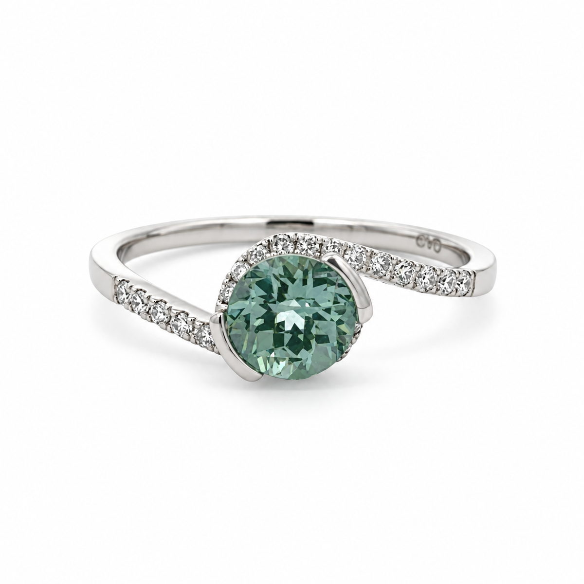 Front view of a 14K white gold ring with a round green sapphire in a partial bezel and a diamond-accented bypass band.