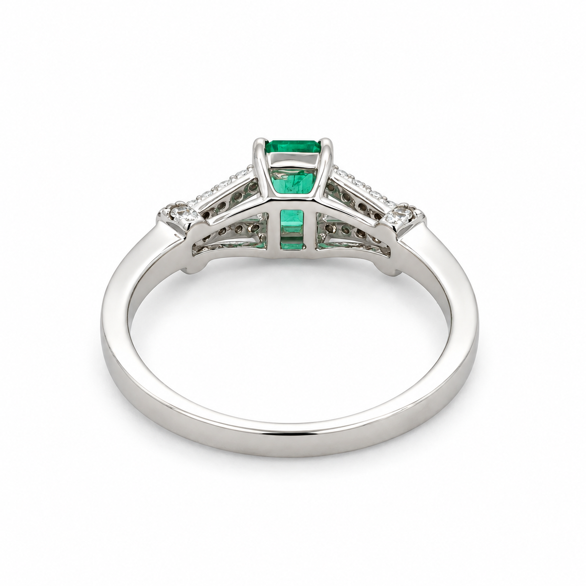 Back view of a 14K white gold ring with a 0.45 CT. emerald and 0.15 CTW. diamond accents on a white background