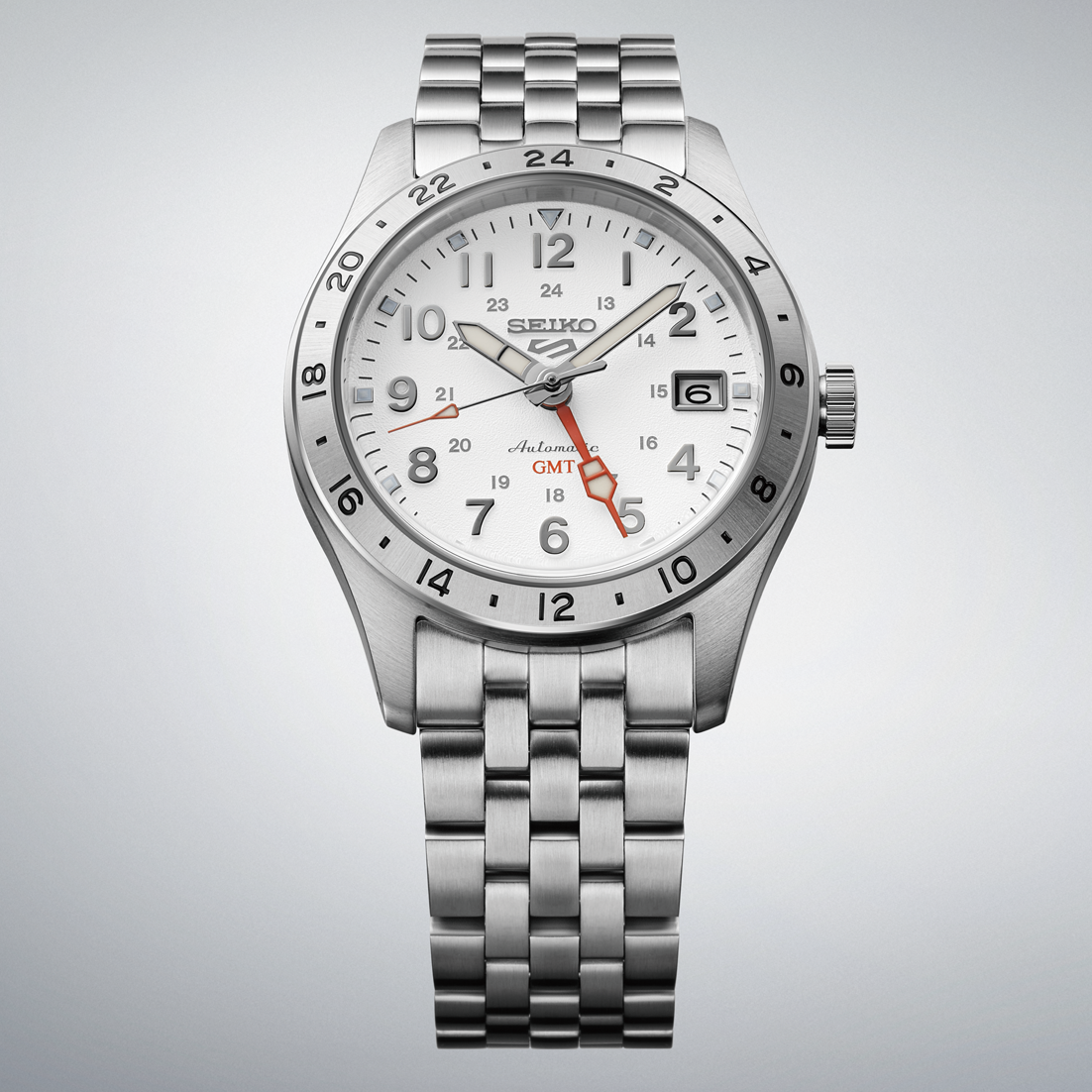 Silver Seiko watch with a white face on a light gray background