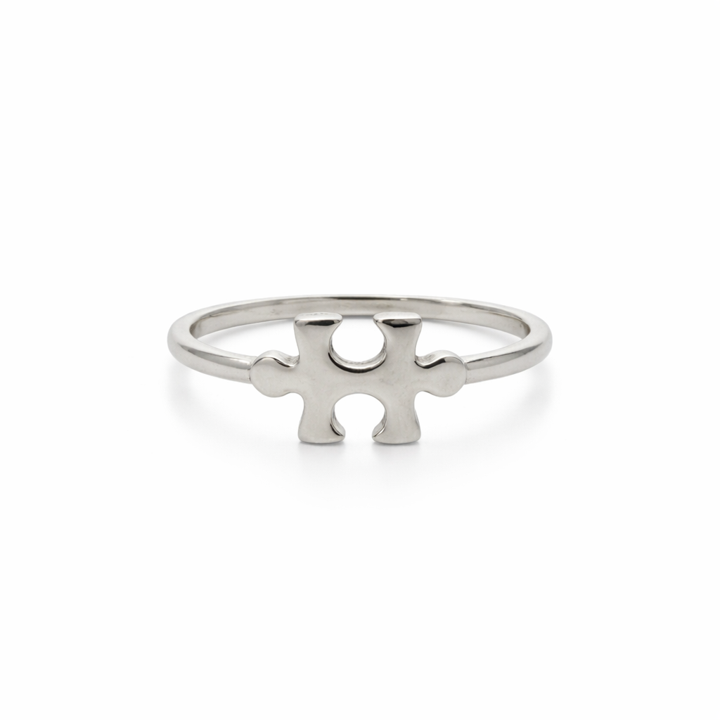 Silver puzzle piece ring on a white background