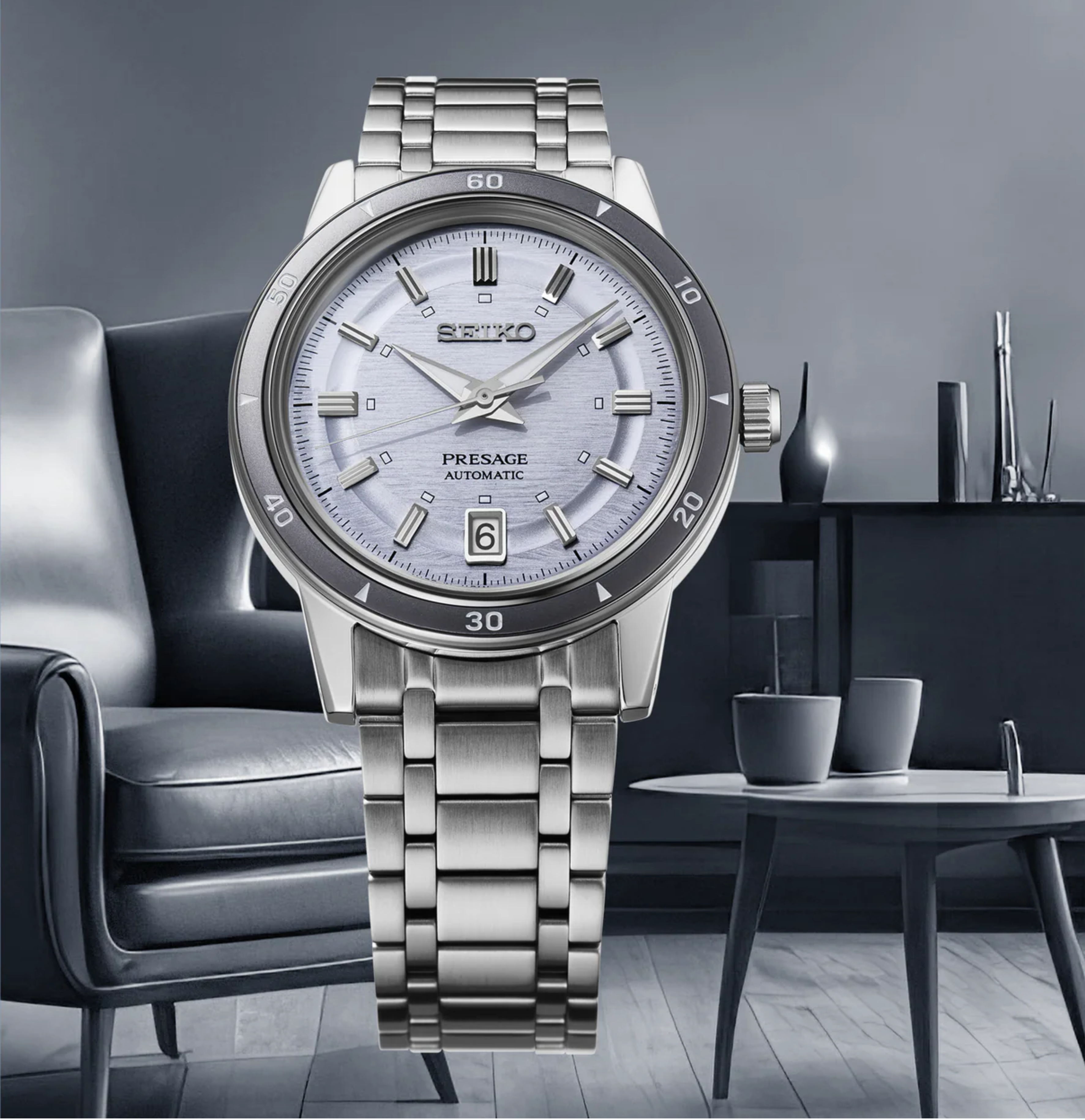 Silver Seiko Presage watch on a blurred background of a modern living room.