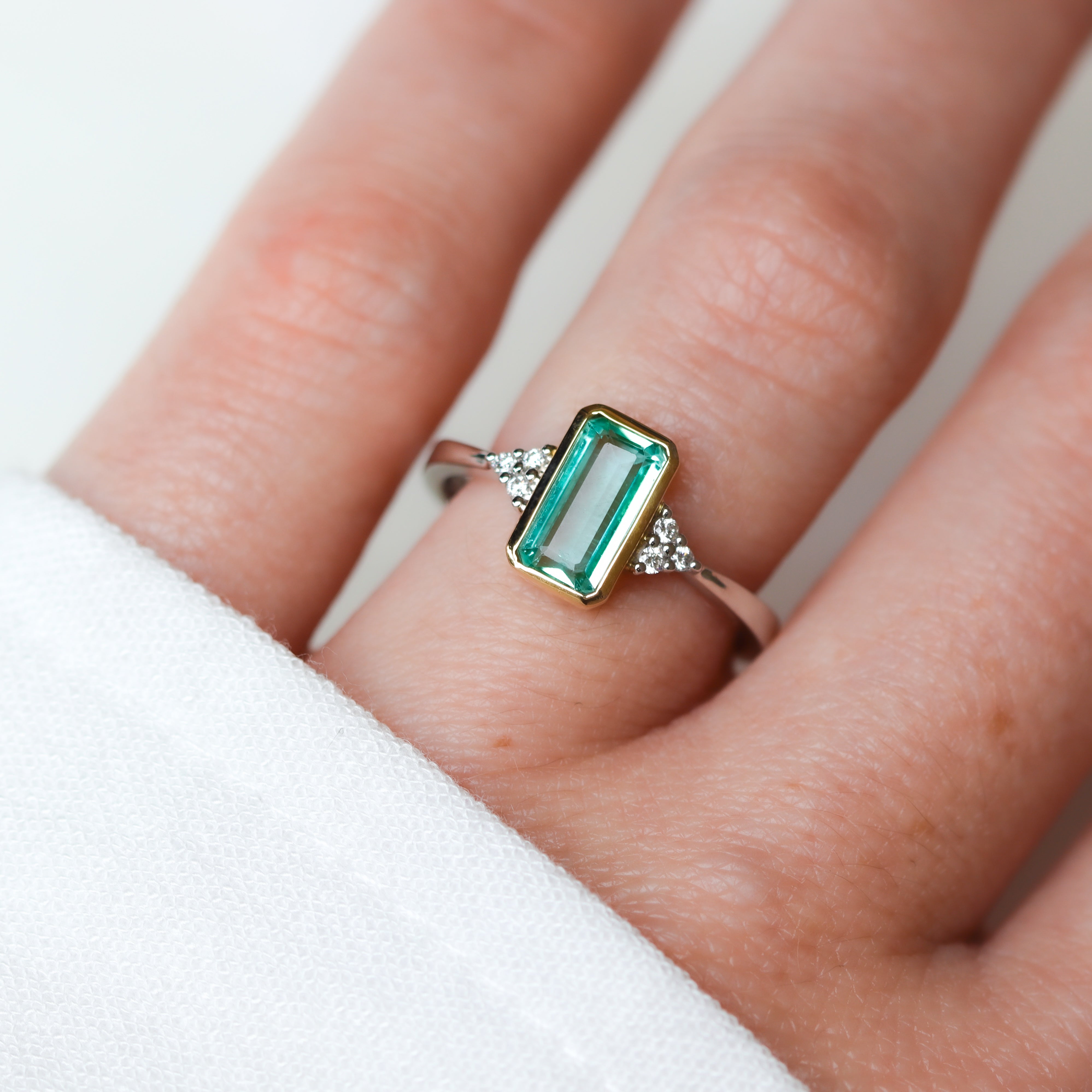 14K Two-Toned Emerald-Cut Mint Green Tourmaline & Diamond Ring on a model's hand