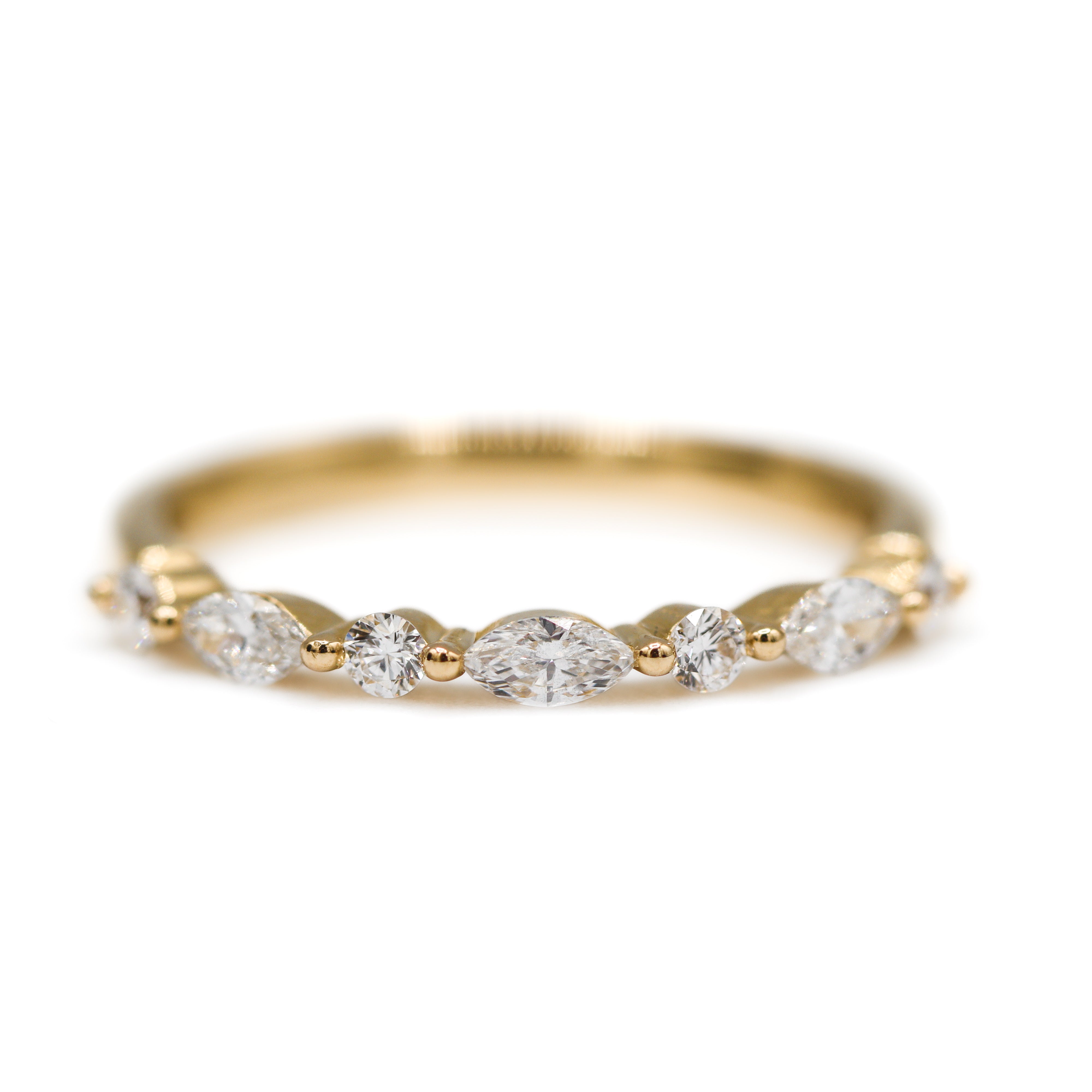 Front view of 14K Yellow Gold 0.5CTW. Lab-Grown Diamond Marquise & Round Wedding Band laying flat on a white surface and background.