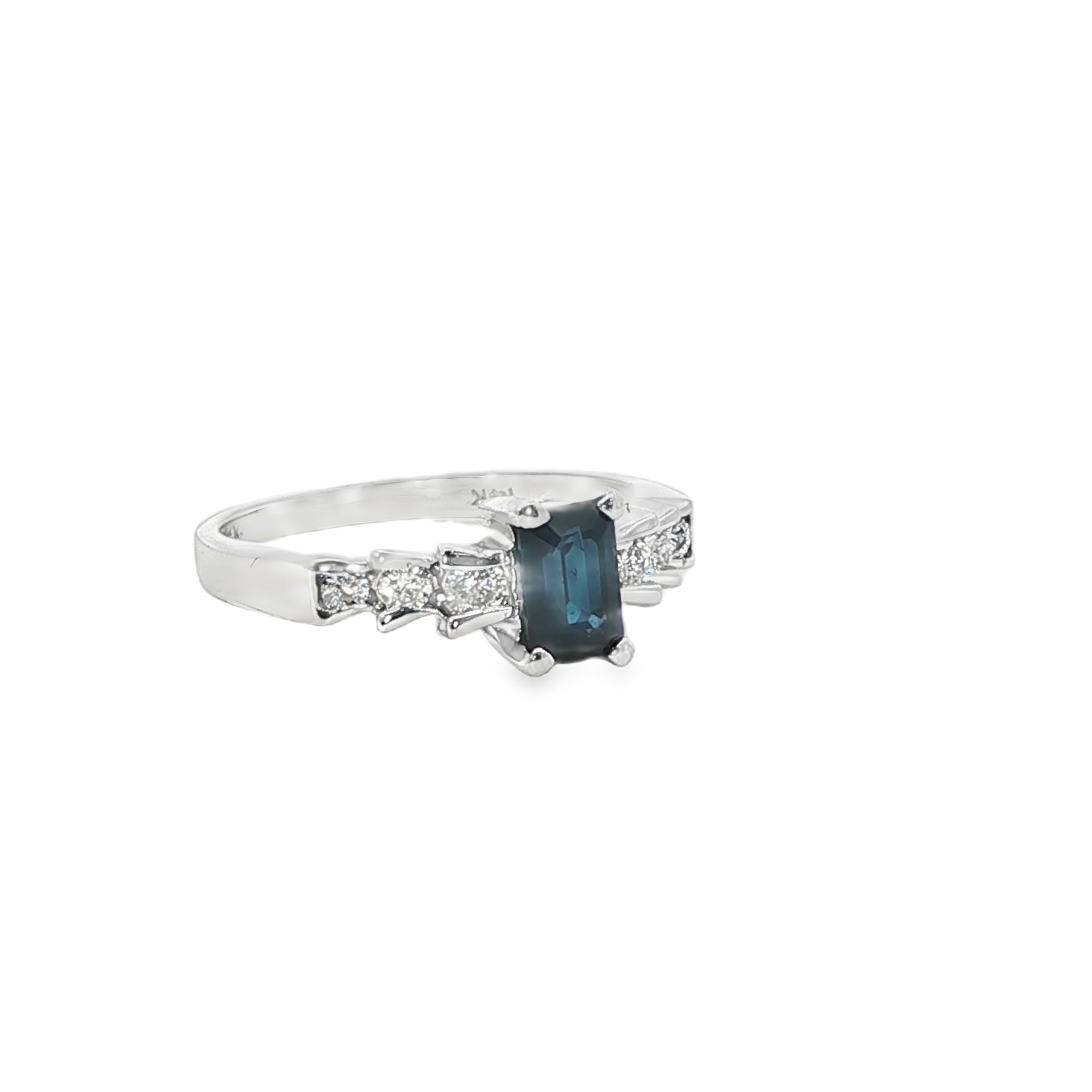 Silver ring with a blue gemstone and smaller diamonds on a white background