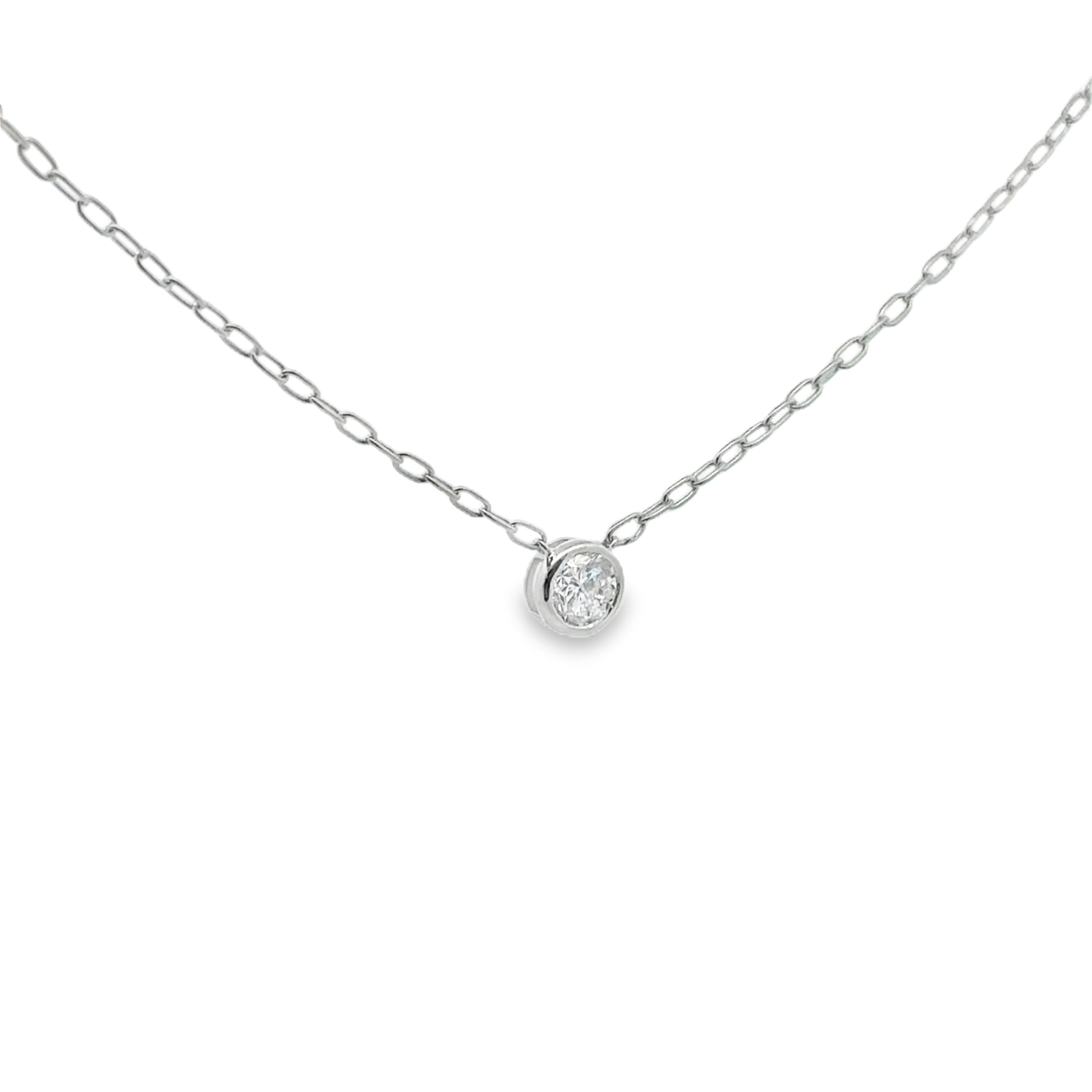Delicate silver necklace with a small round pendant on a white background