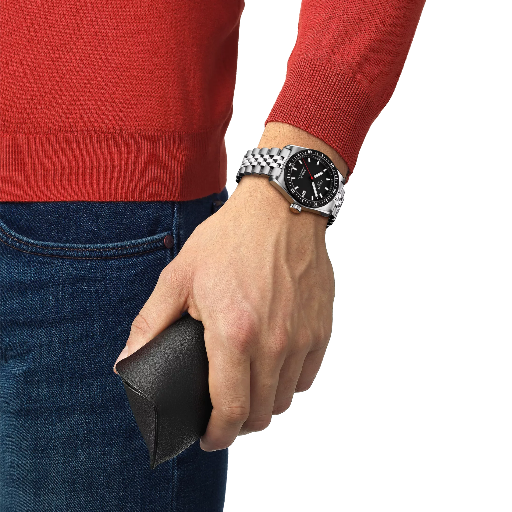 Hand wearing a watch holding a black wallet, with red sweater and blue jeans on a white background