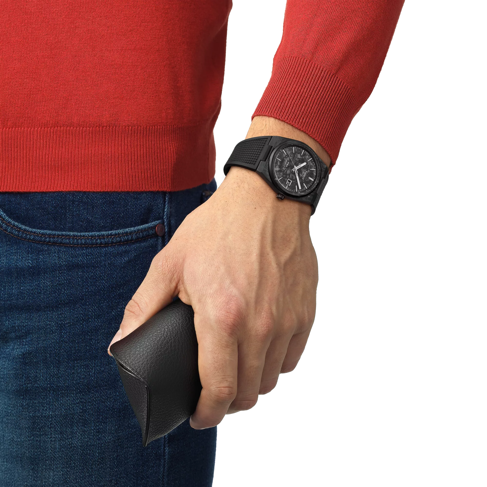 Person wearing a red sweater and blue jeans, holding a black wallet with a black watch on wrist.