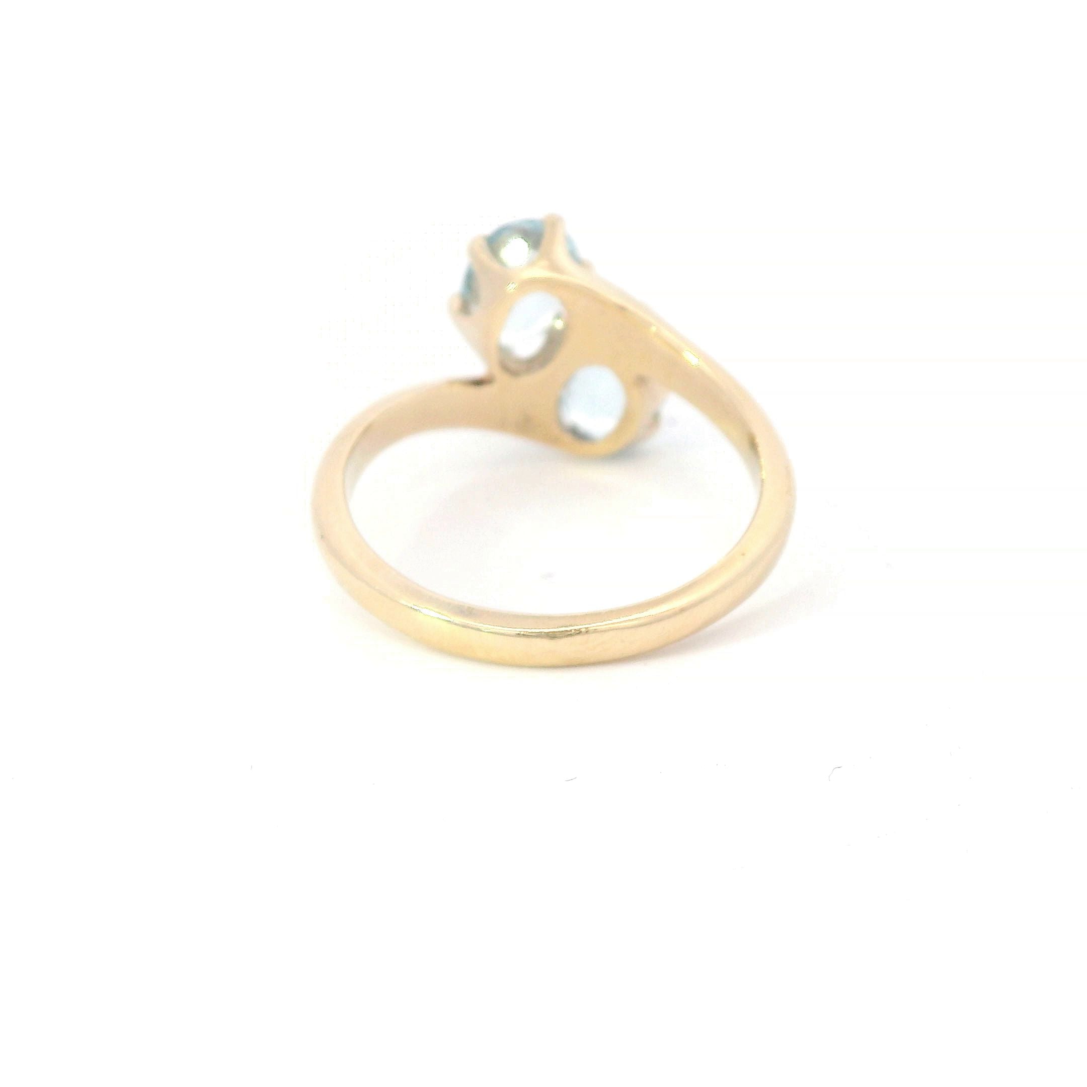 Estate Collection: 14K Yellow Gold 2-Stone Oval Aquamarine Bypass Ring
